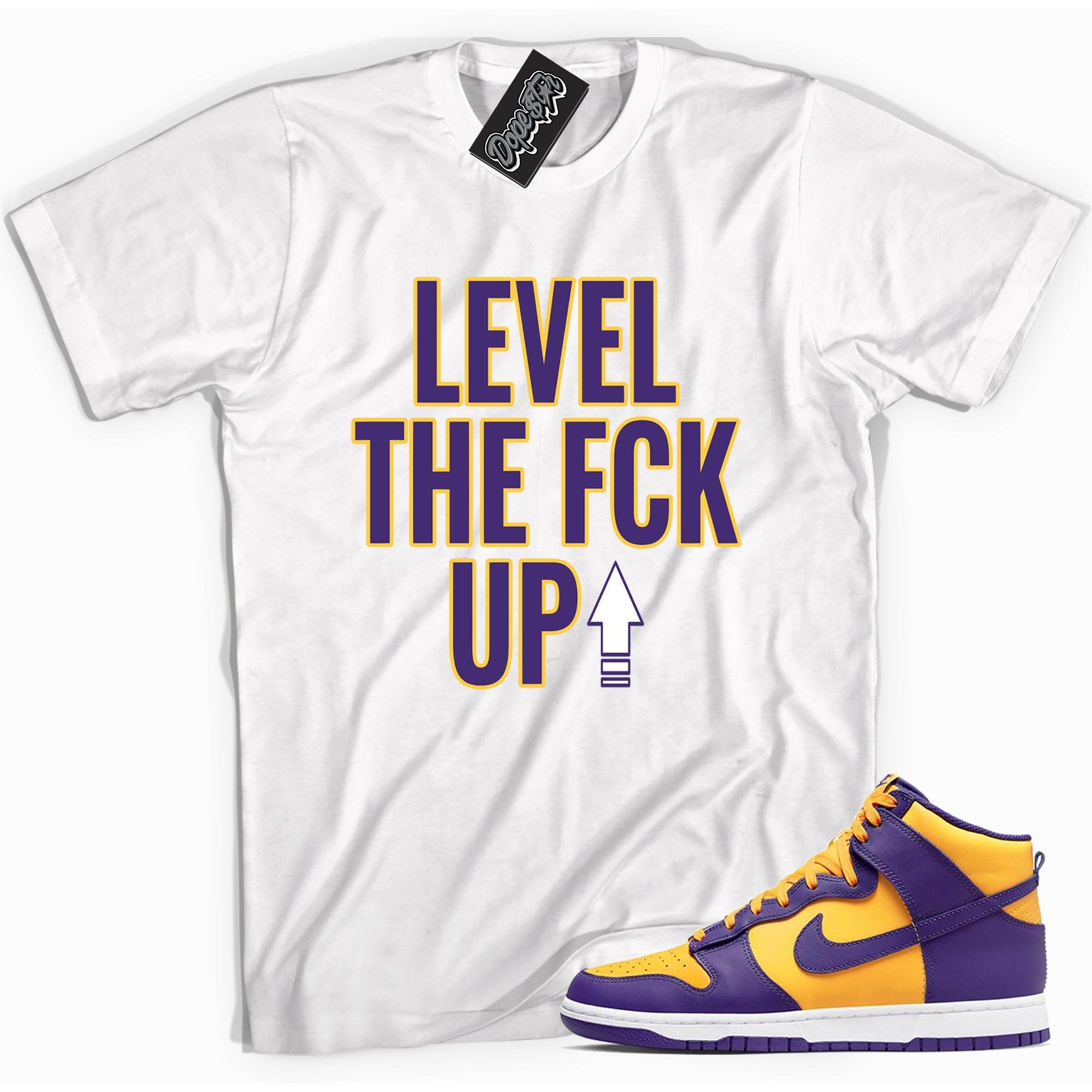 Cool white graphic tee with 'Level Up' print, that perfectly matches Nike Dunk High Lakers sneakers.