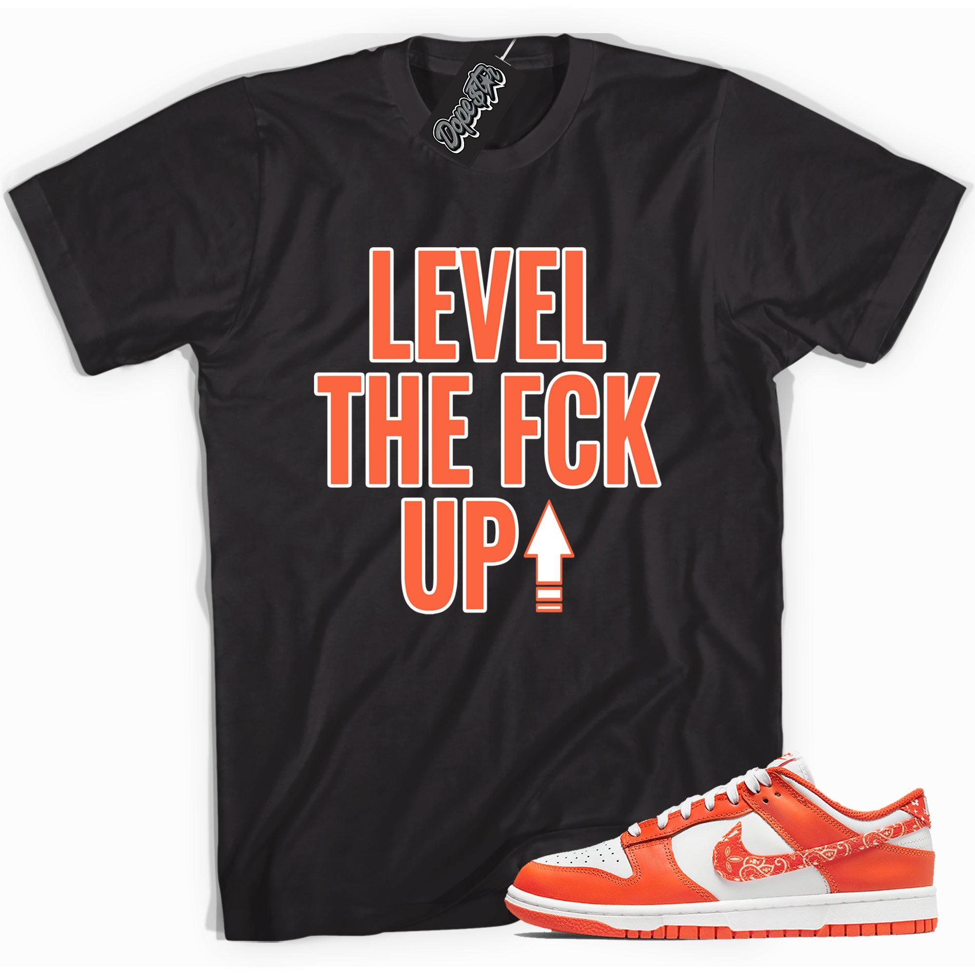 Cool black graphic tee with 'level up' print, that perfectly matches Nike Dunk Low Essential Paisley Pack Orange sneakers.