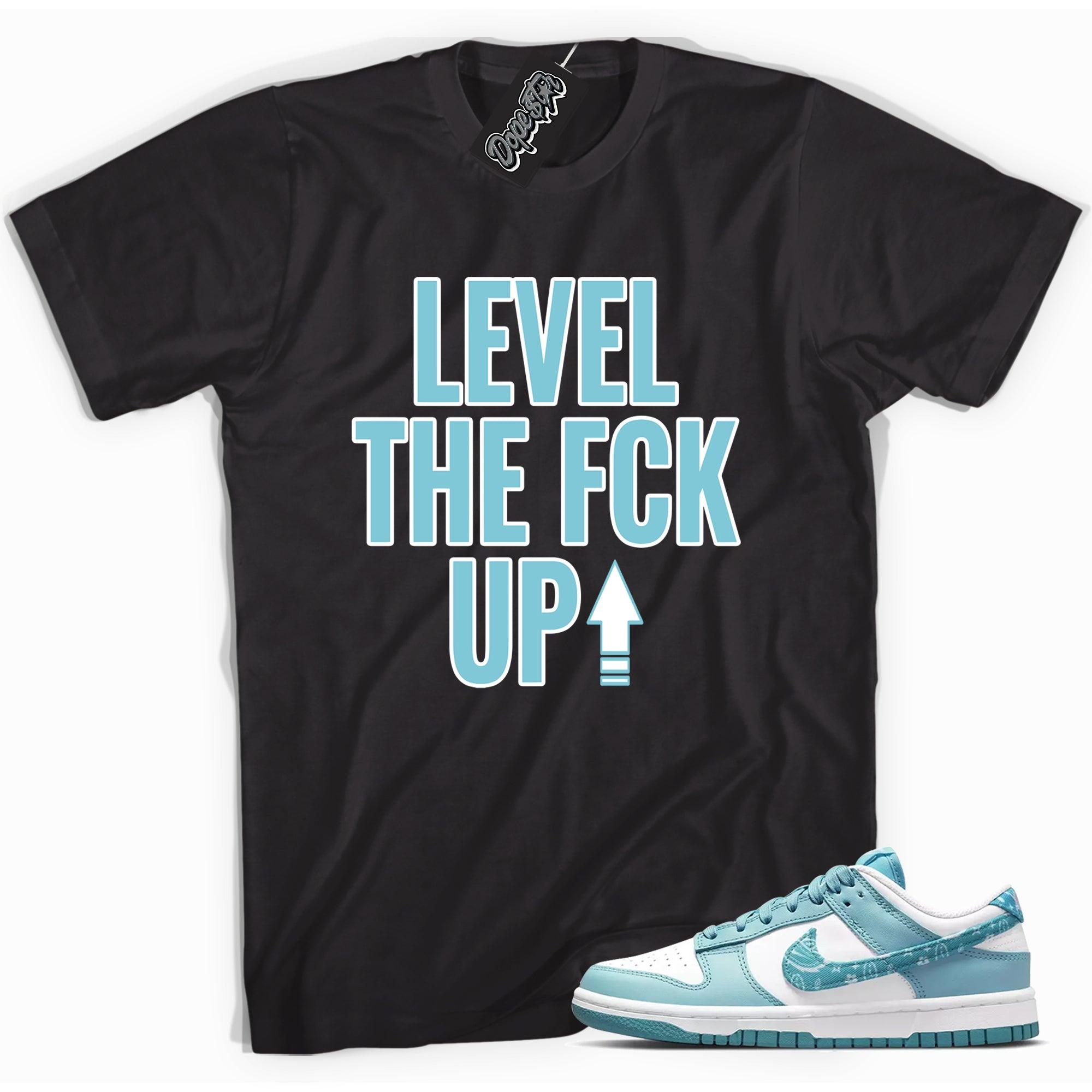 Cool black graphic tee with 'Level Up' print, that perfectly matches Nike Dunk Low Essential Paisley Pack Worn Blue sneakers.