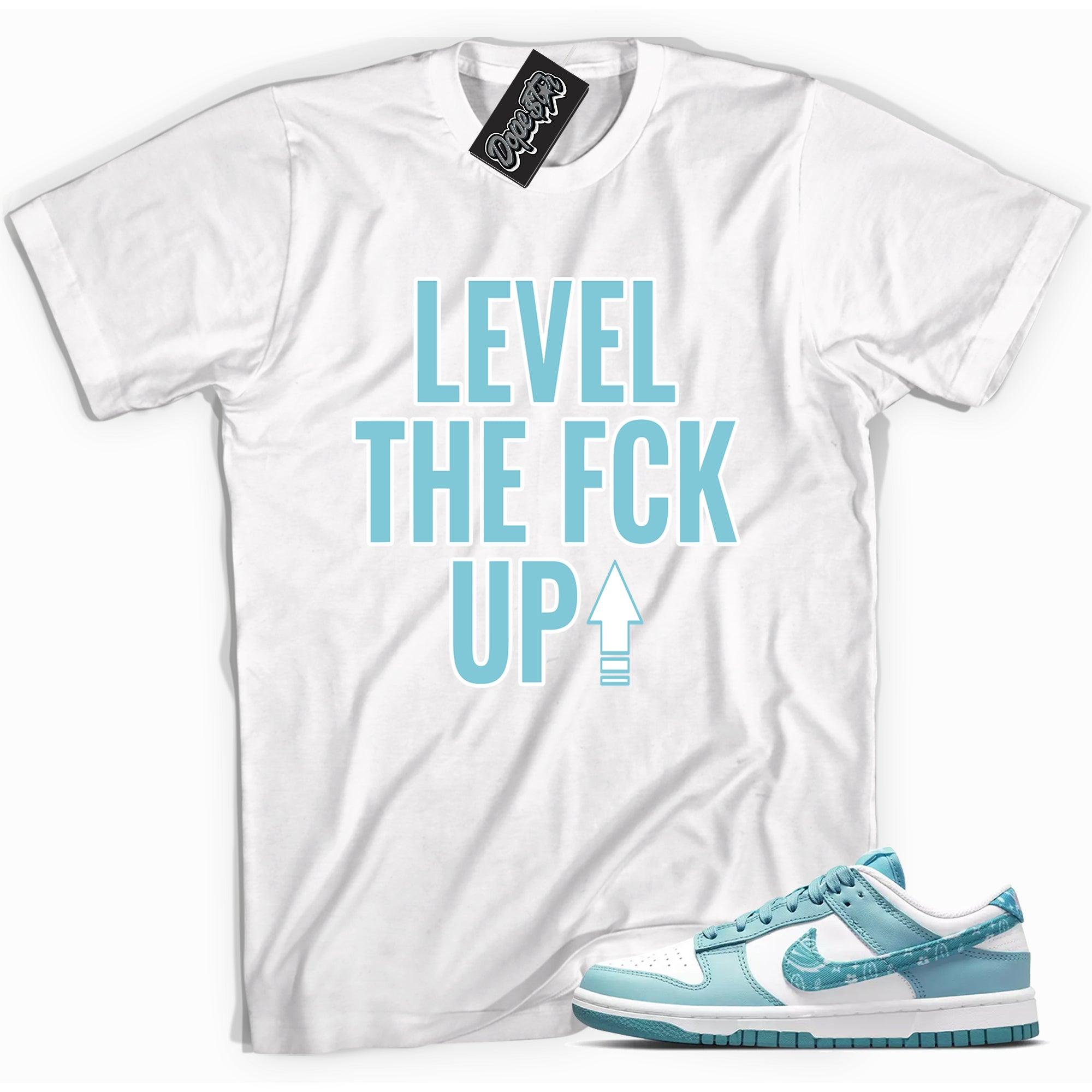 Cool white graphic tee with 'Level Up' print, that perfectly matches Nike Dunk Low Essential Paisley Pack Worn Blue sneakers.