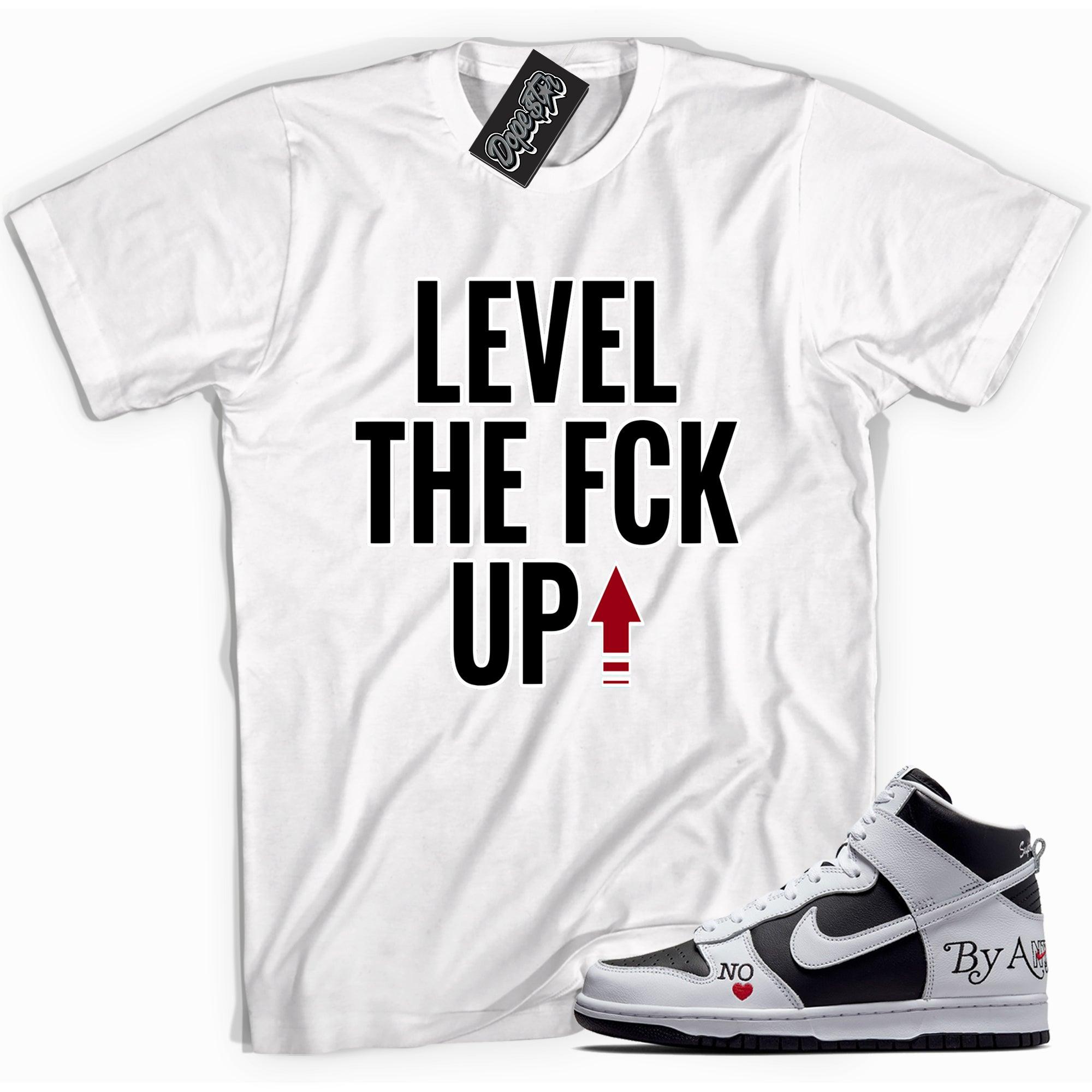 Cool white graphic tee with 'Level Up' print, that perfectly matches Nike SB Dunk High Supreme Toe sneakers.
