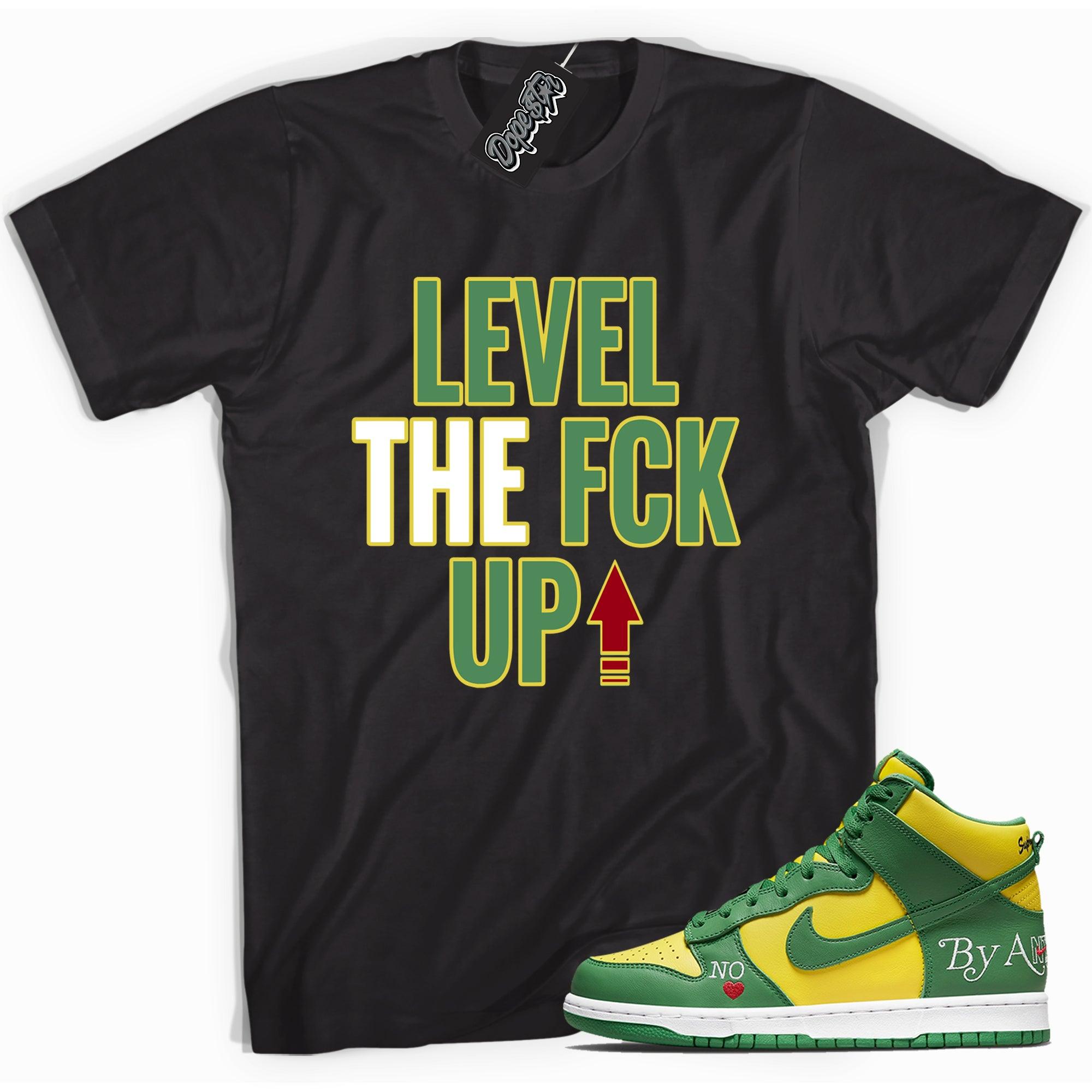 Cool black graphic tee with 'Level Up' print, that perfectly matches Nike SB Dunk High Supreme By Any Means Brazil Toe sneakers.