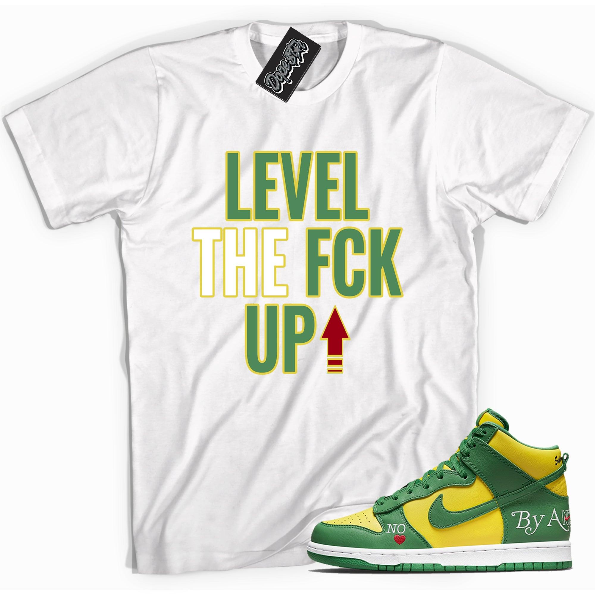 Cool white graphic tee with 'Level Up' print, that perfectly matches Nike SB Dunk High Supreme By Any Means Brazil Toe sneakers.