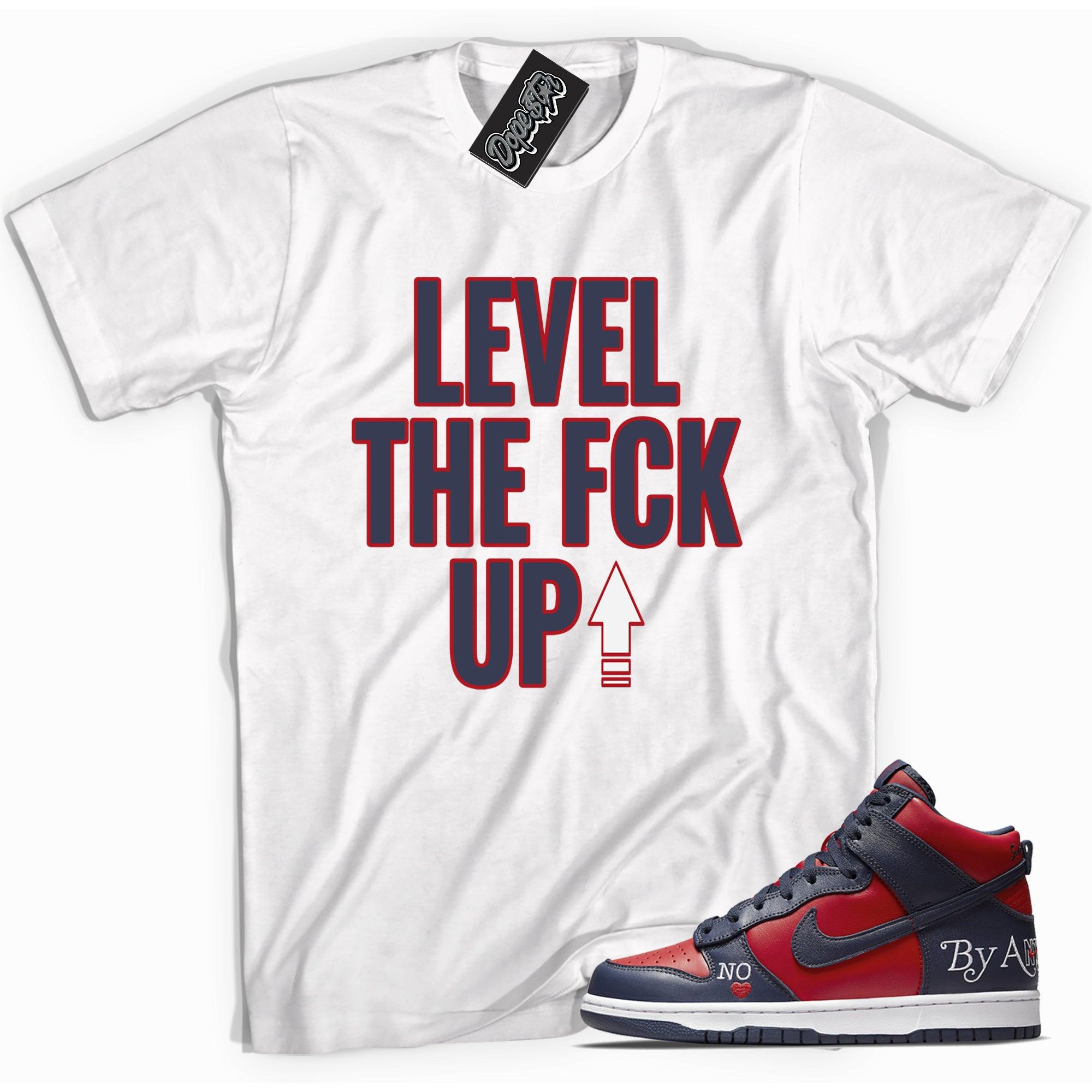 Cool white graphic tee with 'Level Up' print, that perfectly matches Nike SB Dunk High Supreme Navy Toe sneakers.