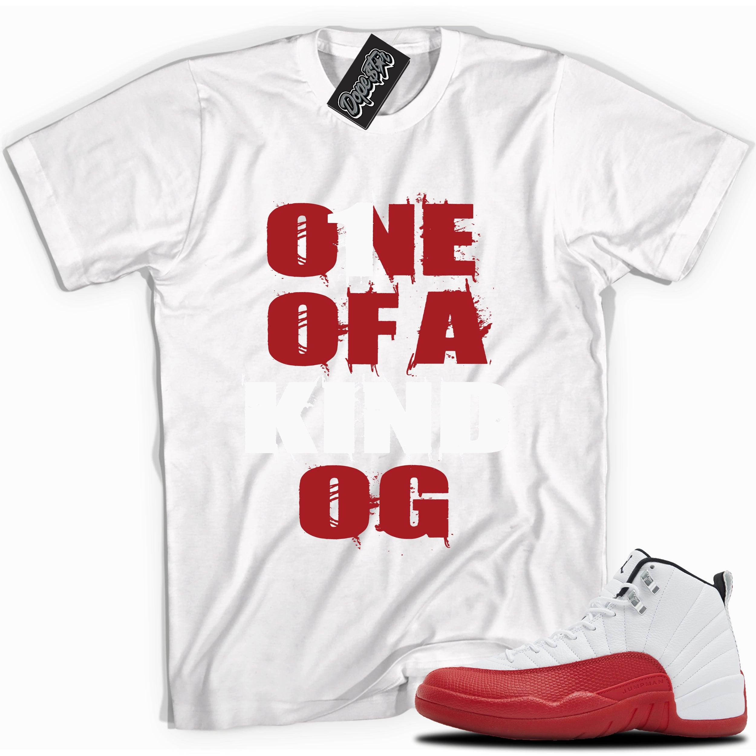 Cool White graphic tee with “ONE OF A KIND OG” print, that perfectly matches Air Jordan 12 Retro Cherry Red 2023 red and white sneakers 