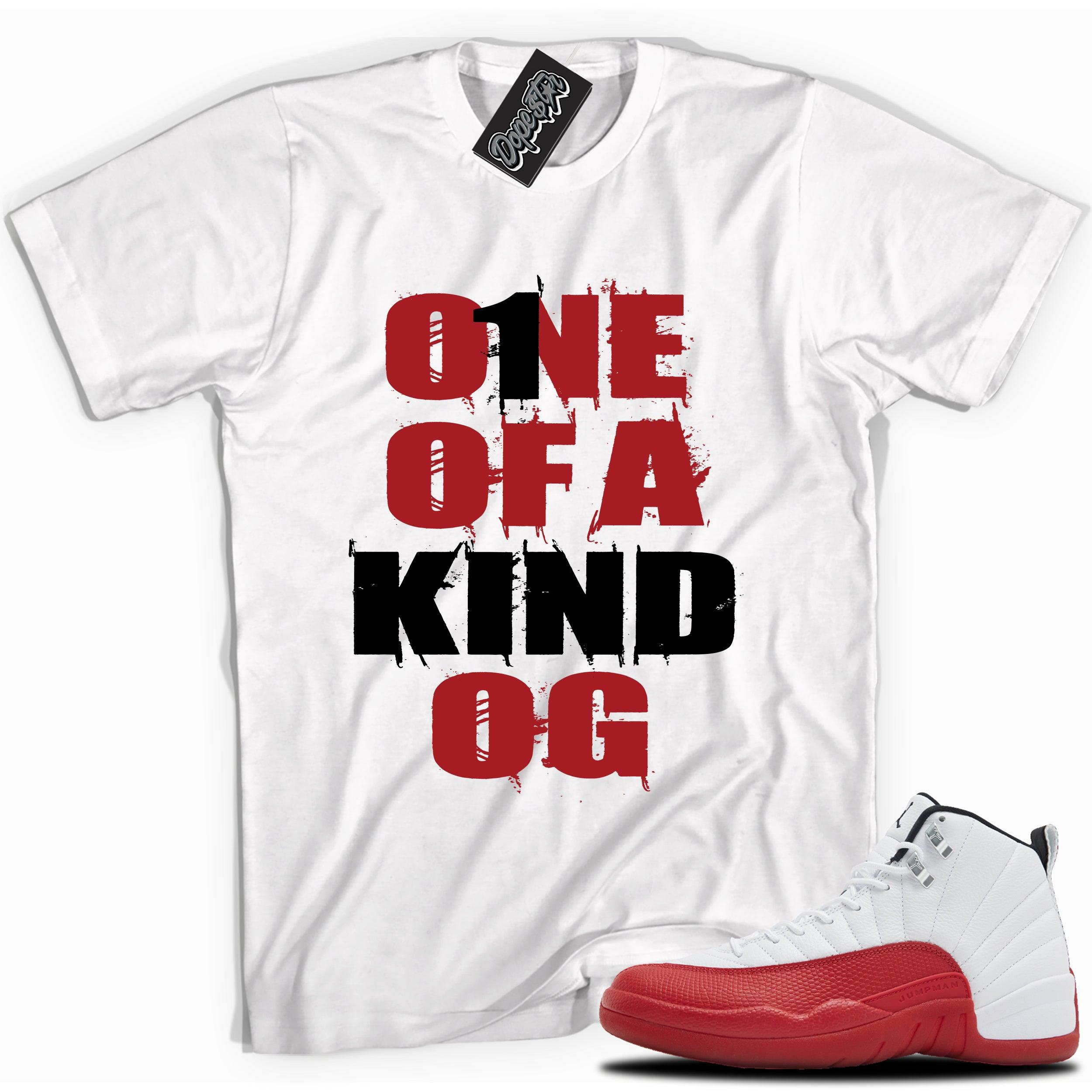 Cool White graphic tee with “ONE OF A KIND OG” print, that perfectly matches Air Jordan 12 Retro Cherry Red 2023 red and white sneakers 