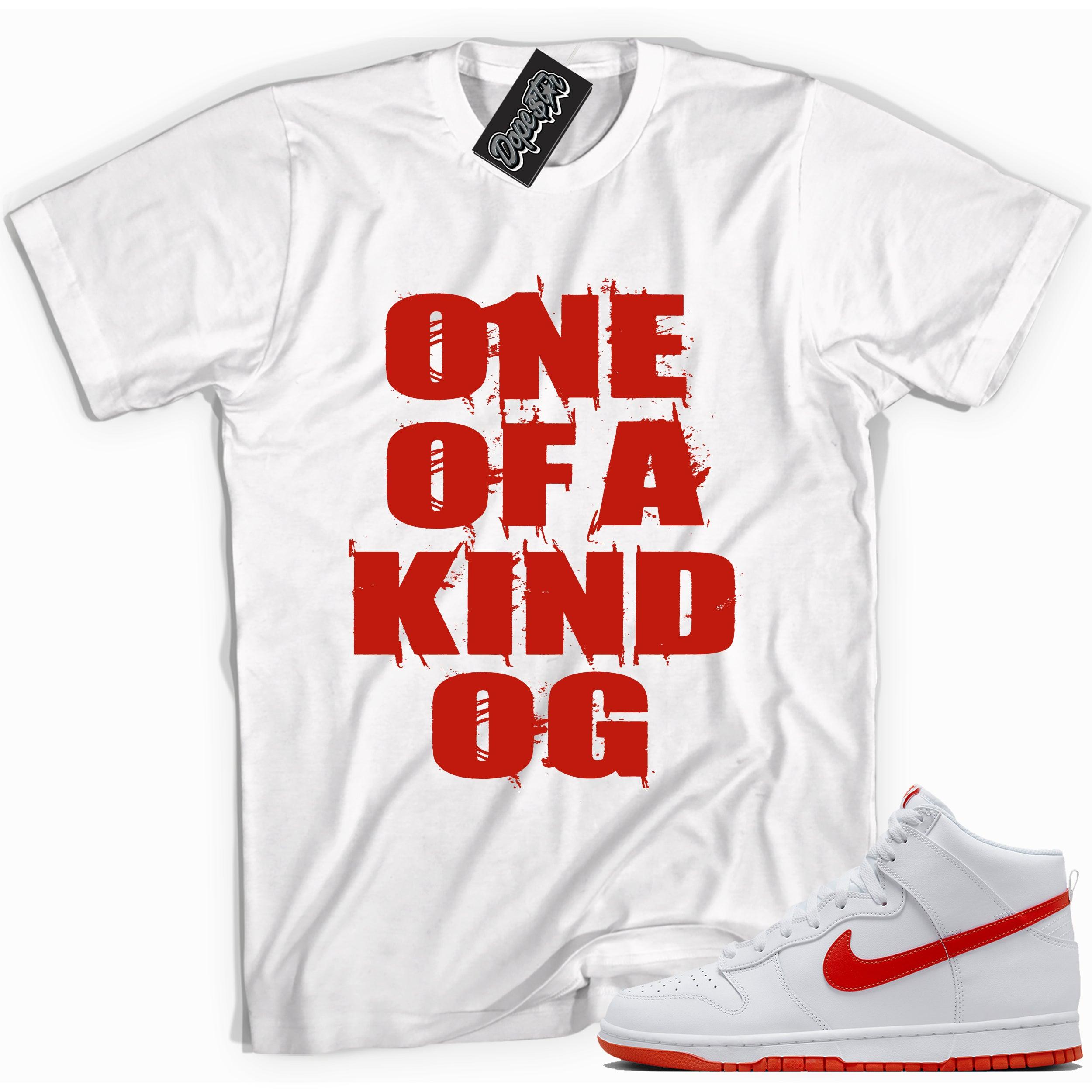 Cool white graphic tee with 'one of kind OG' print, that perfectly matches Nike Dunk High White Picante Red sneakers.