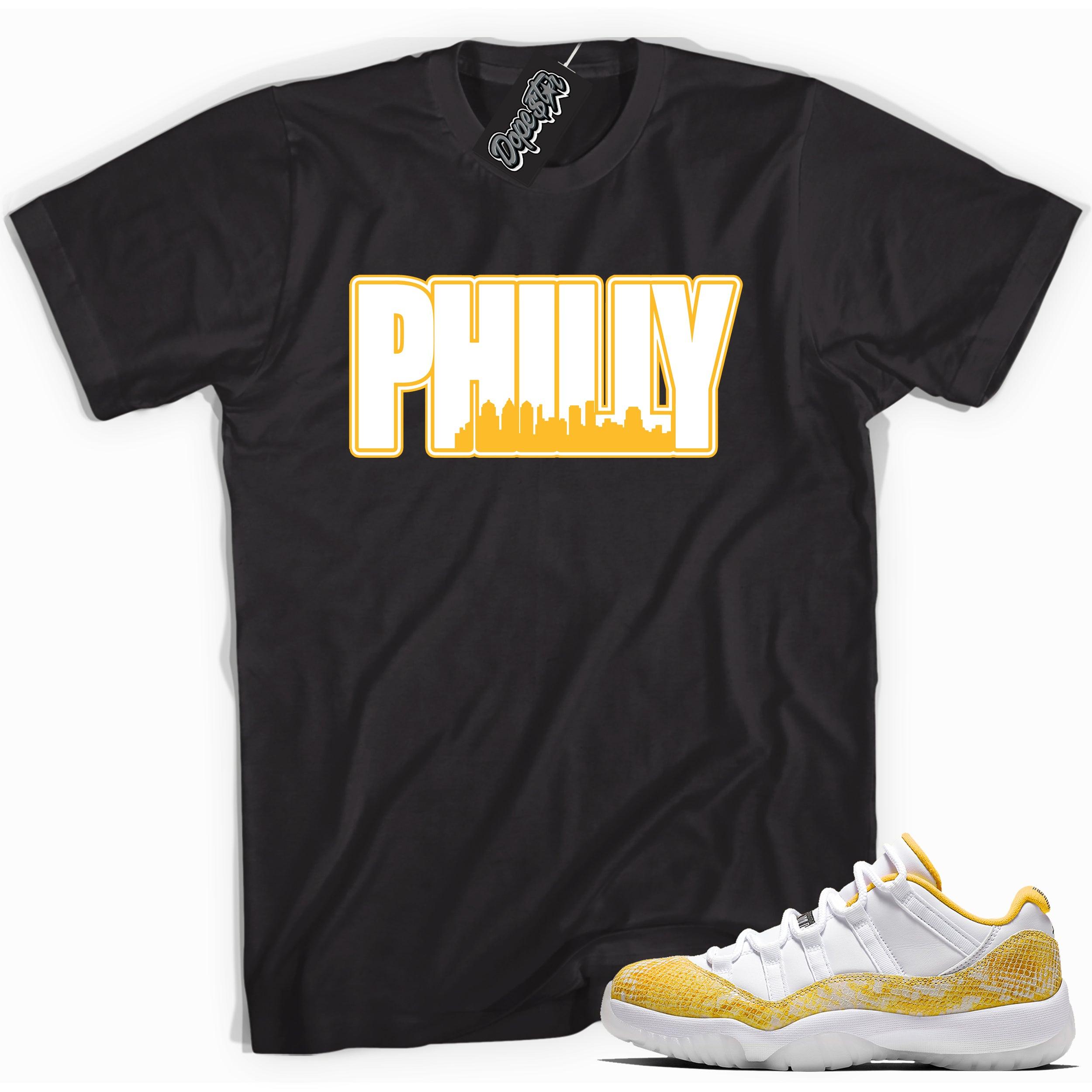 Cool black graphic tee with 'philly' print, that perfectly matches  Air Jordan 11 Retro Low Yellow Snakeskin sneakers