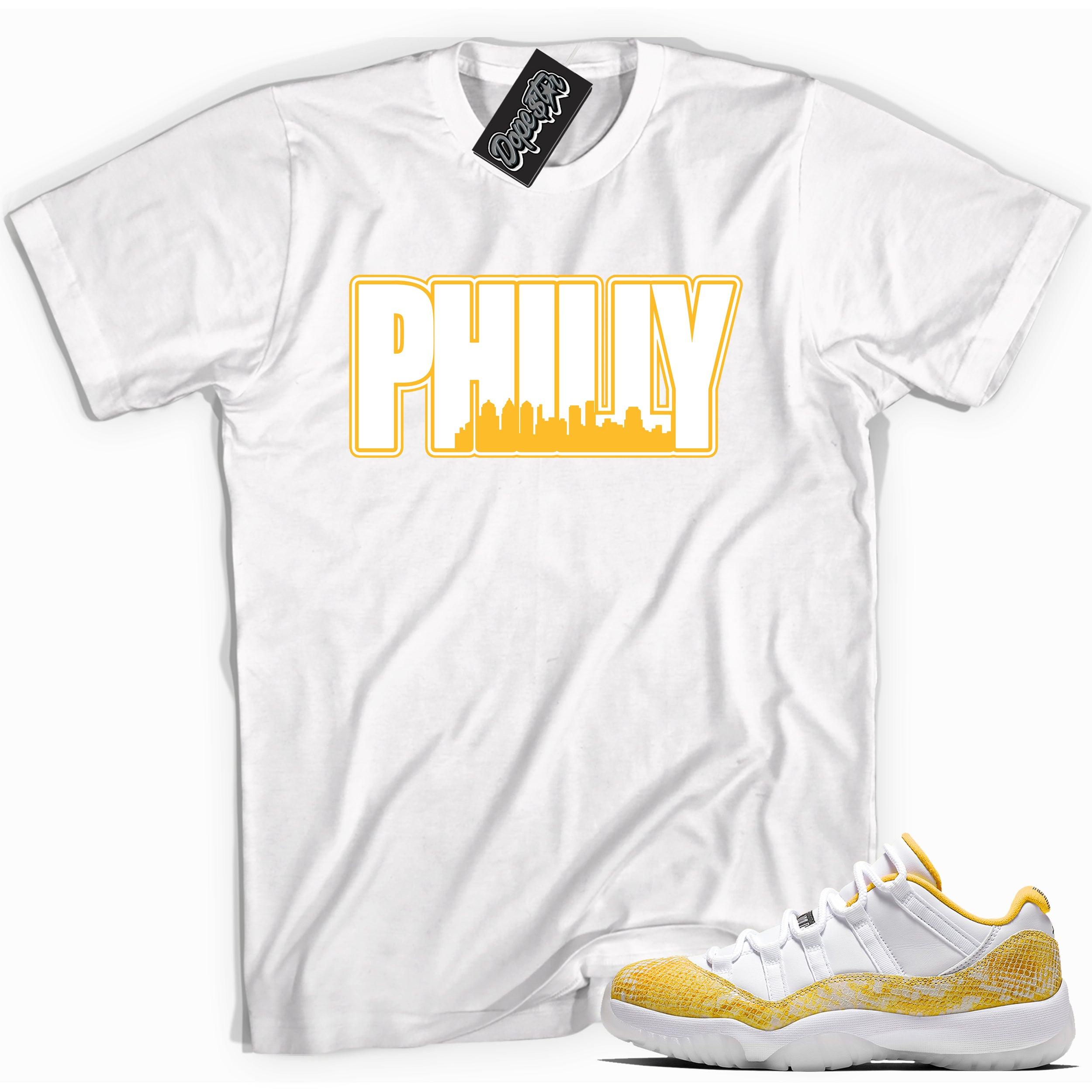 Cool white graphic tee with 'philly' print, that perfectly matches Air Jordan 11 Retro Low Yellow Snakeskin sneakers