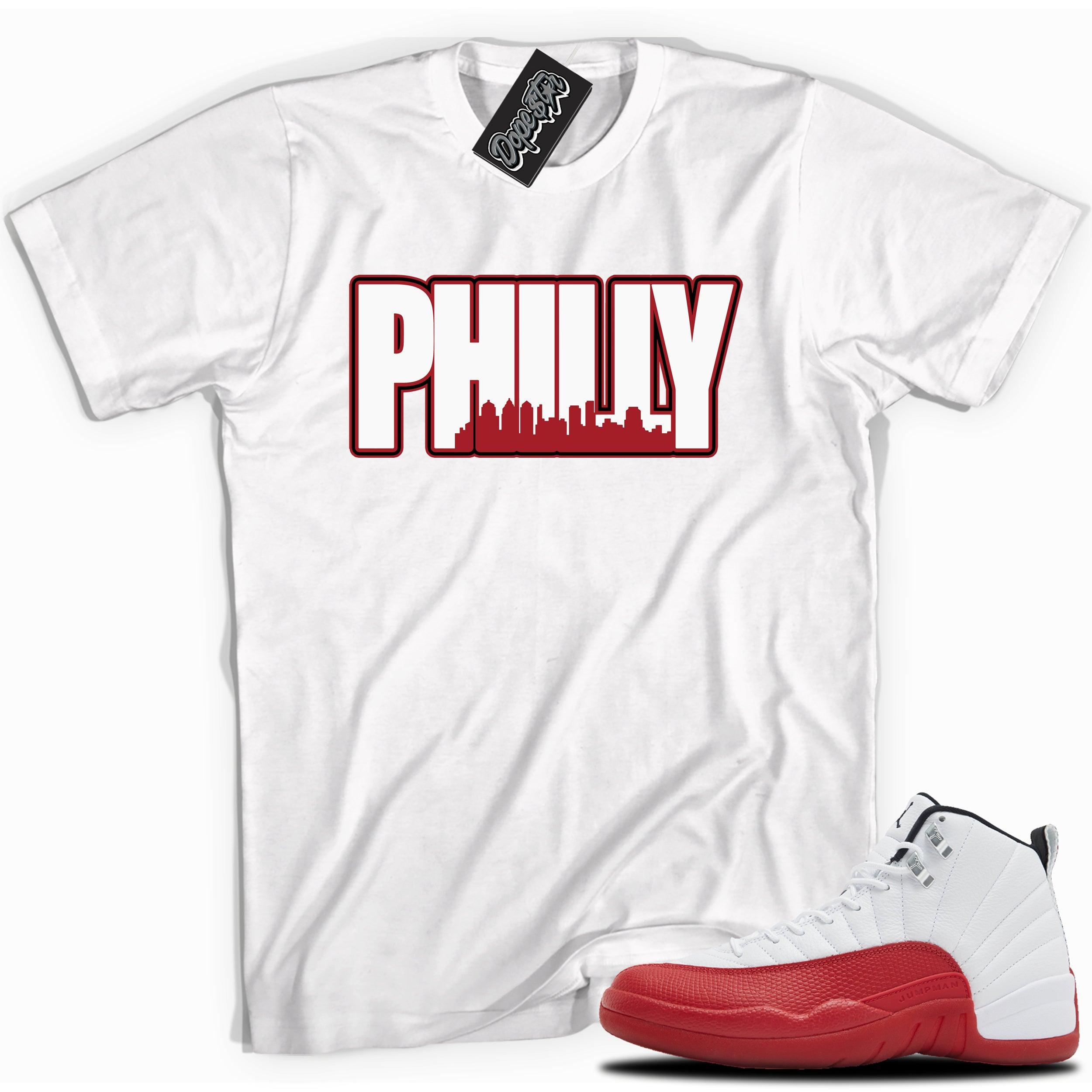 Cool White graphic tee with “PHILLY” print, that perfectly matches Air Jordan 12 Retro Cherry Red 2023 red and white sneakers