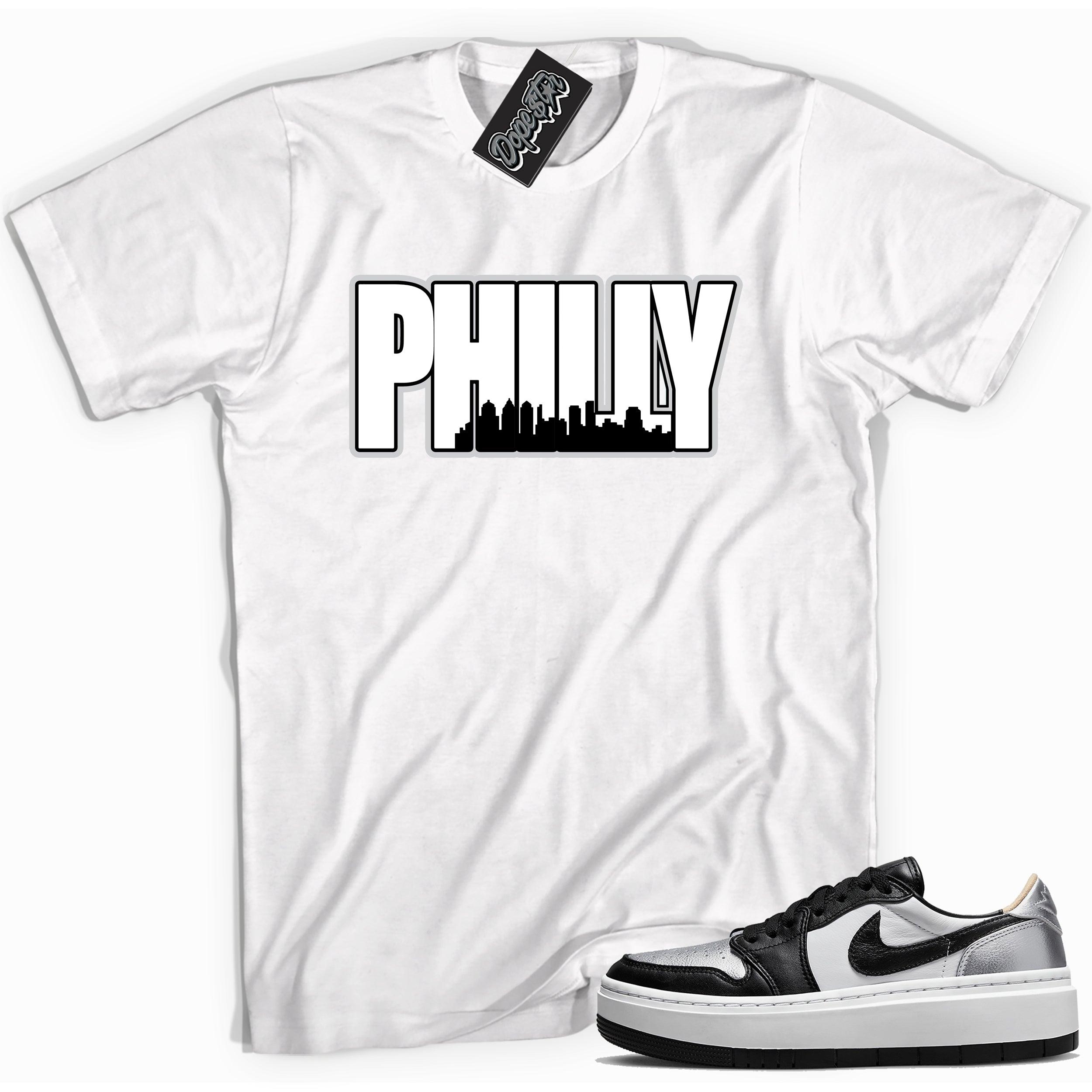 Cool white graphic tee with 'philly Philadelphia ' print, that perfectly matches Air Jordan 1 Elevate Low SE Silver Toe sneakers.
