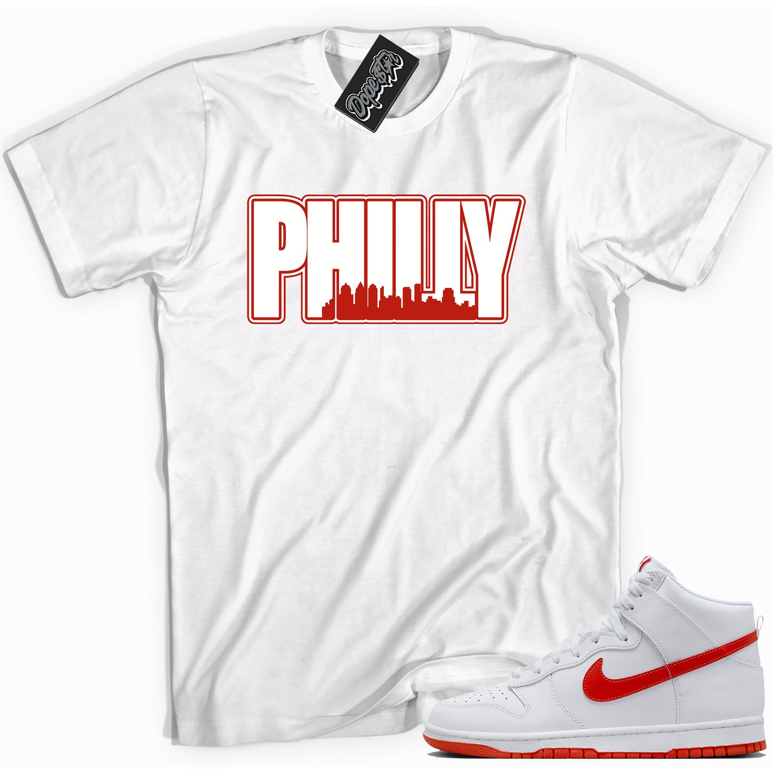 Cool white graphic tee with 'philly' print, that perfectly matches Nike Dunk High White Picante Red sneakers.