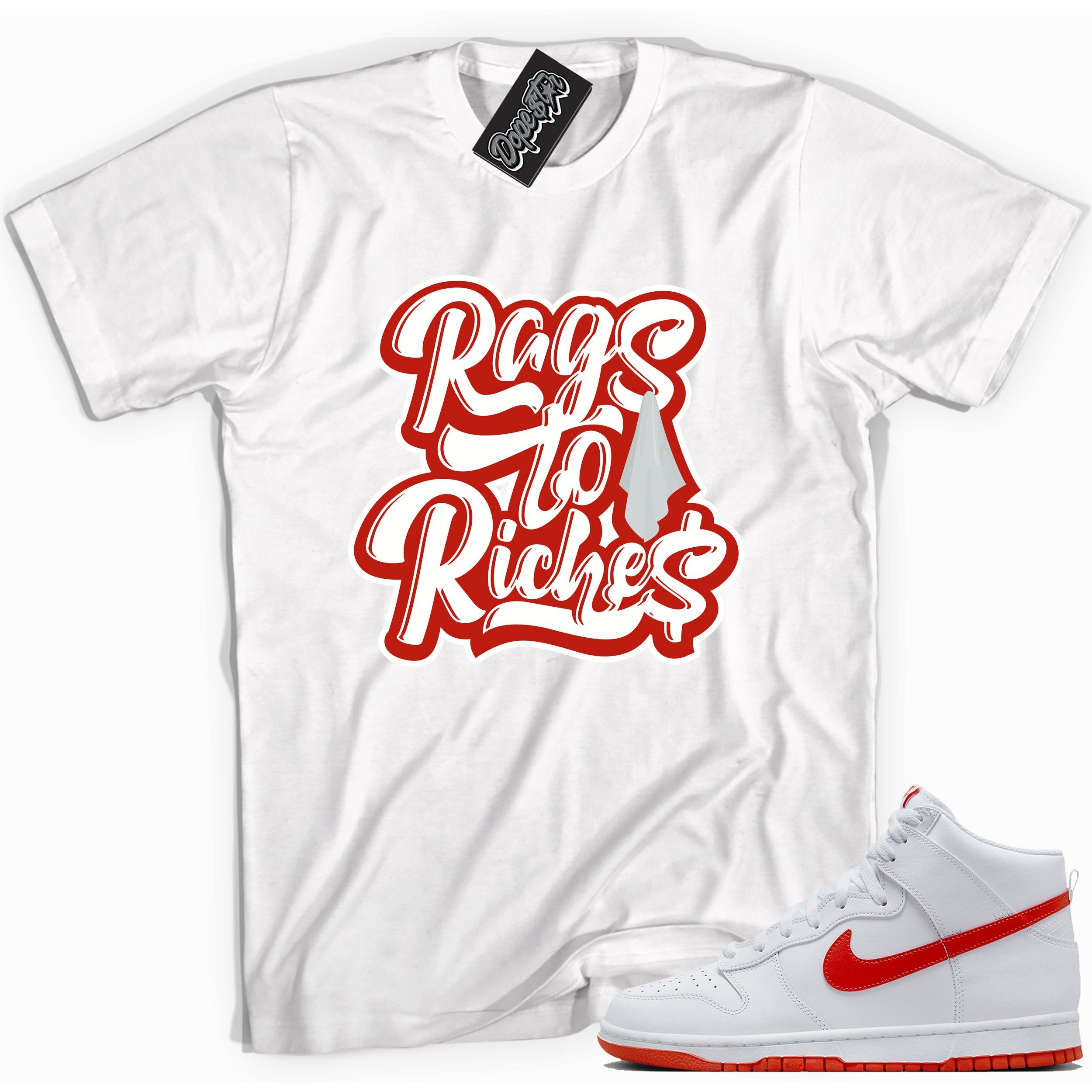 Cool white graphic tee with 'rags to riches' print, that perfectly matches Nike Dunk High White Picante Red sneakers.