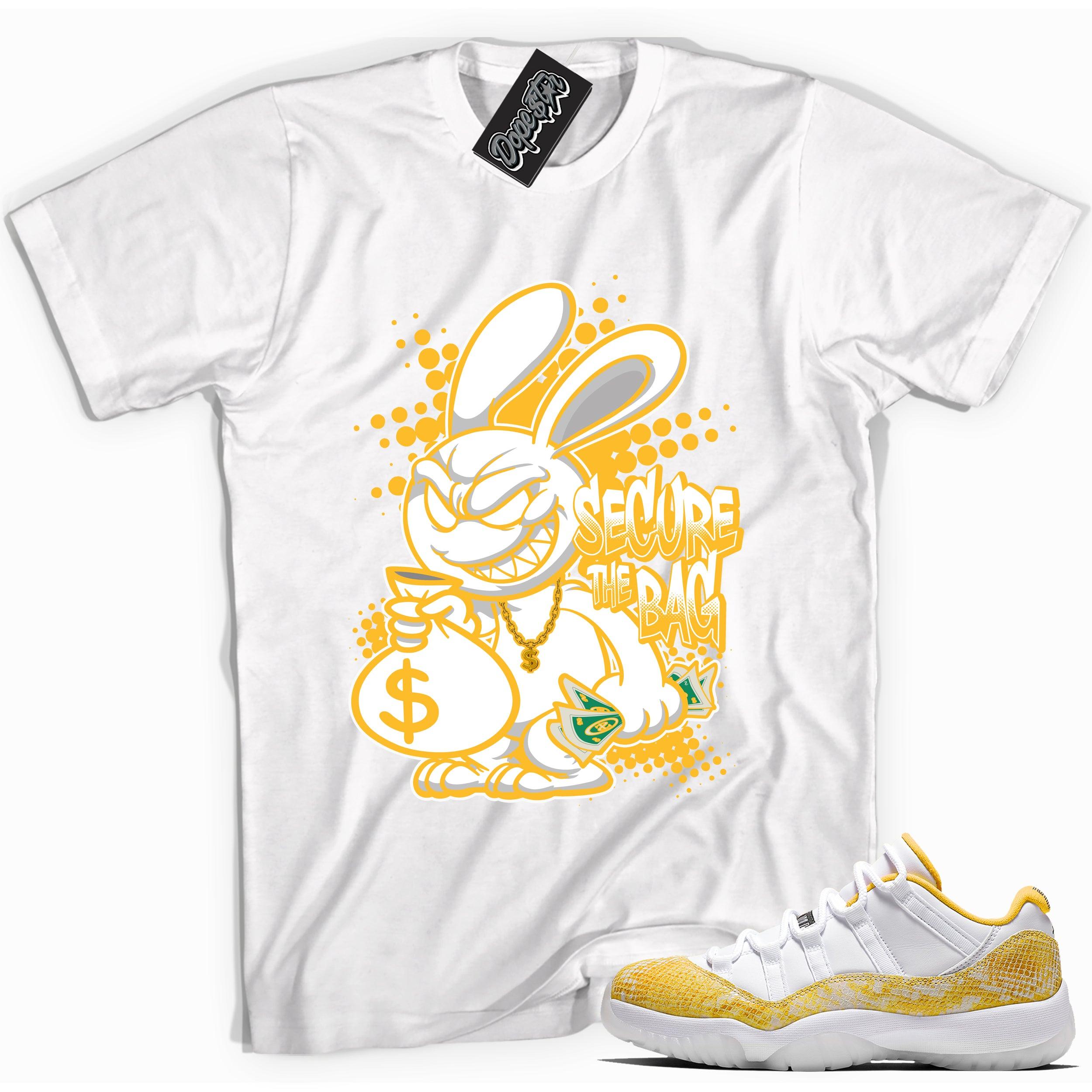 Cool white graphic tee with 'secure the bag' print, that perfectly matches Air Jordan 11 Retro Low Yellow Snakeskin sneakers