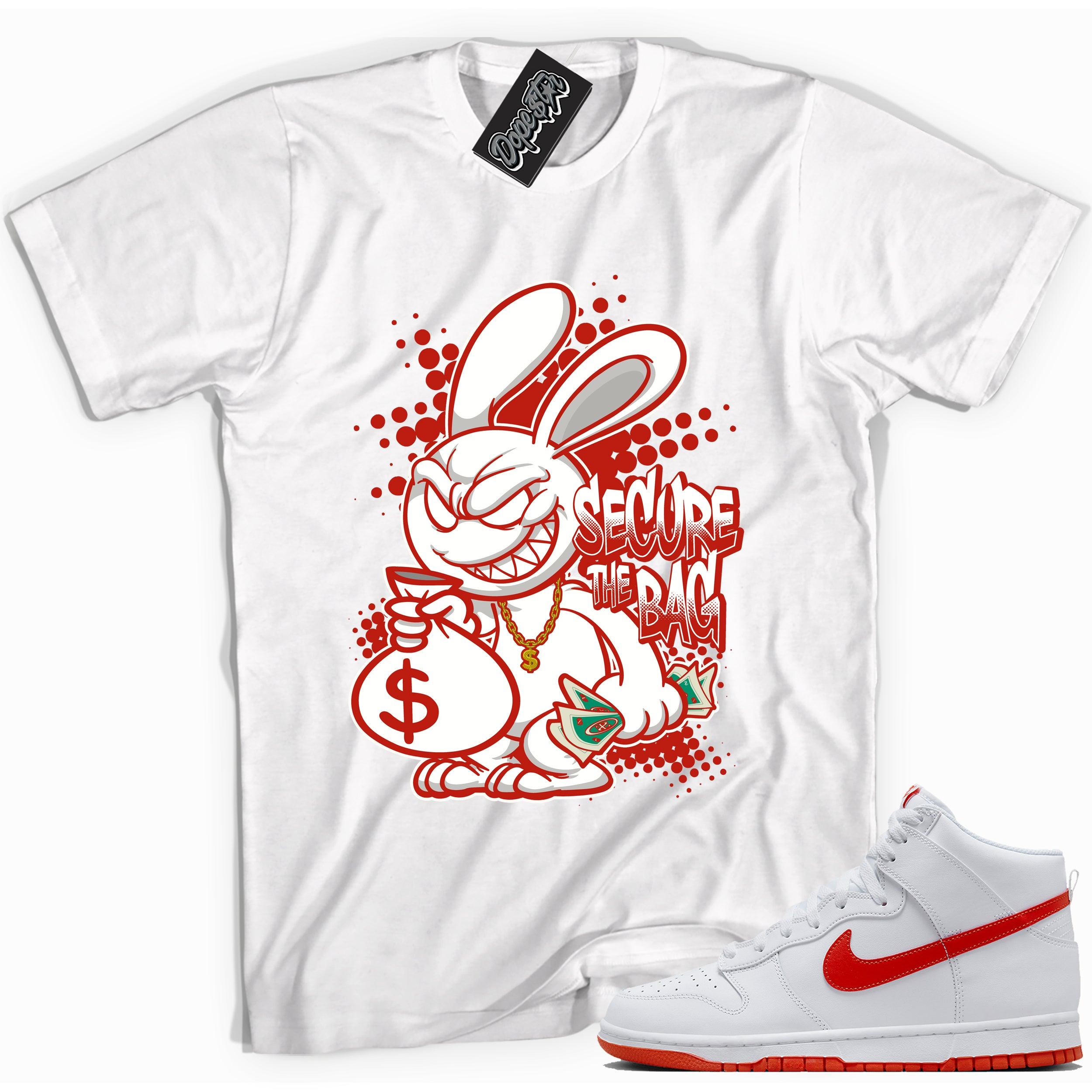 Cool white graphic tee with 'secure the bag' print, that perfectly matches Nike Dunk High White Picante Red sneakers.