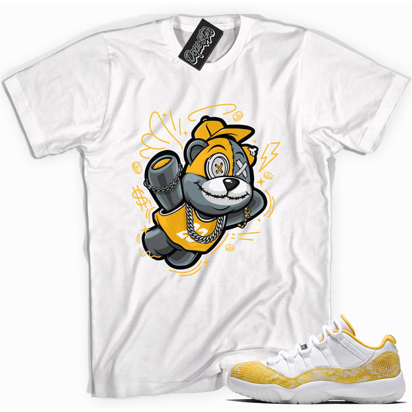 Cool white graphic tee with 'slam dunk bear' print, that perfectly matches Air Jordan 11 Retro Low Yellow Snakeskin sneakers