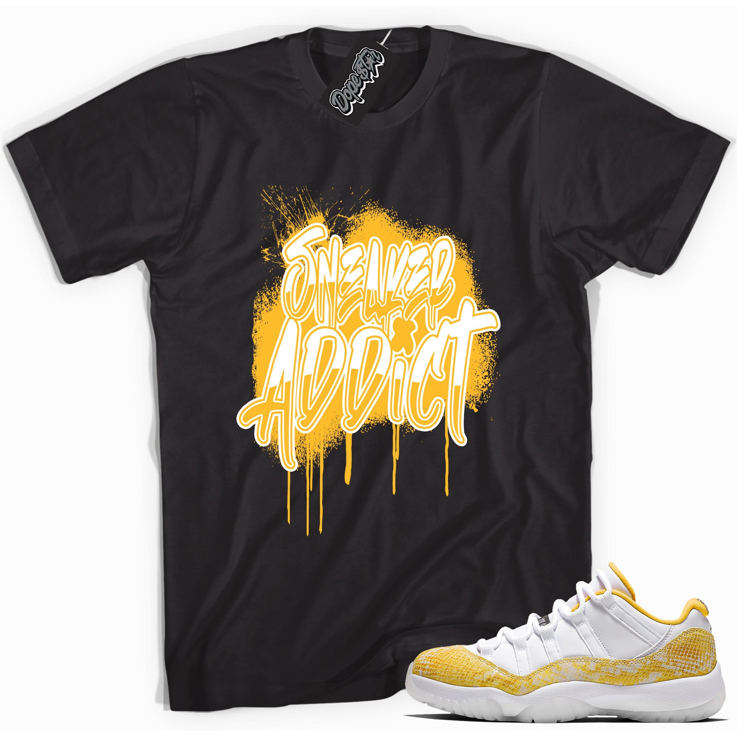 Cool black graphic tee with 'sneaker addict' print, that perfectly matches  Air Jordan 11 Retro Low Yellow Snakeskin sneakers
