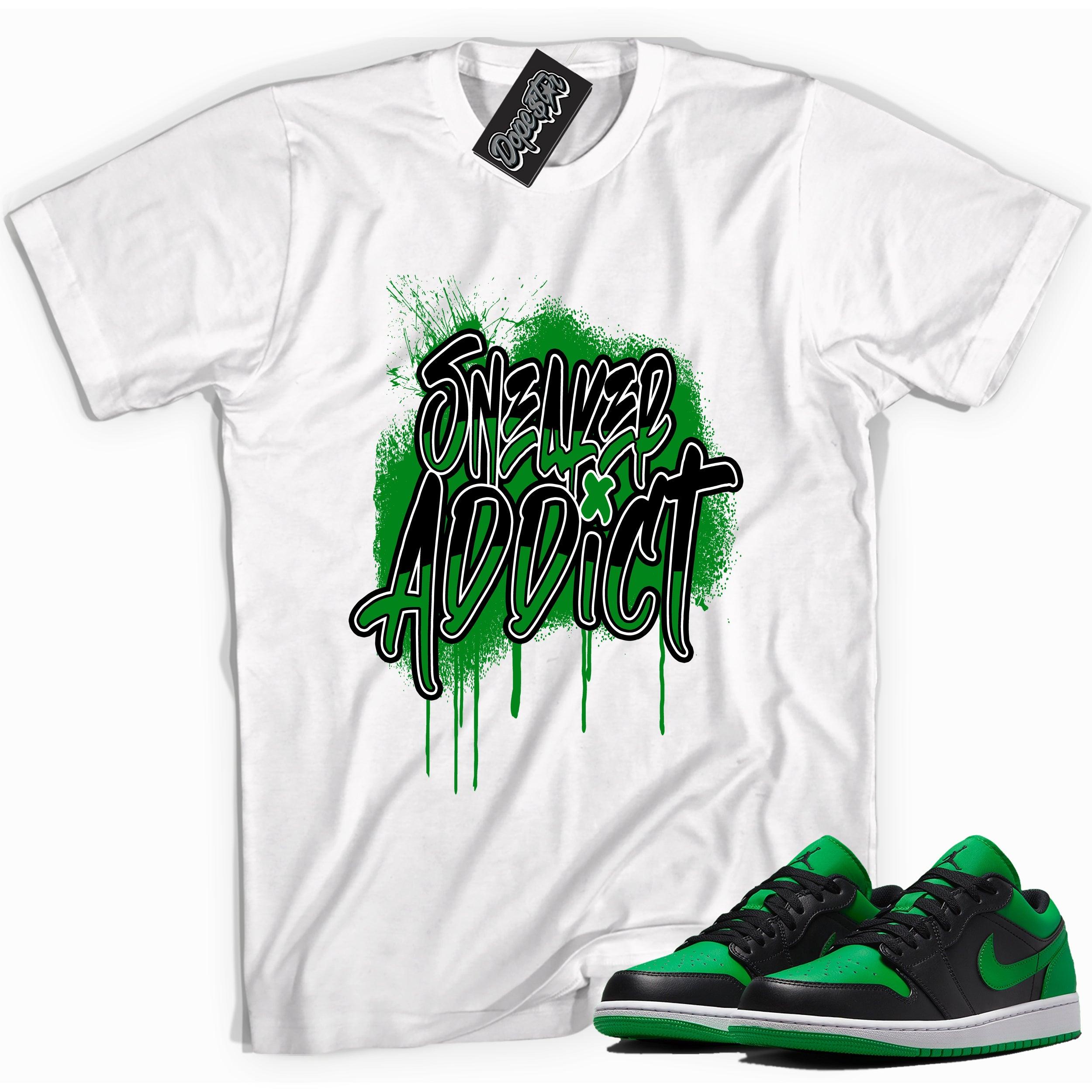 Cool white graphic tee with 'sneaker addict' print, that perfectly matches Air Jordan 1 Low Lucky Green sneakers