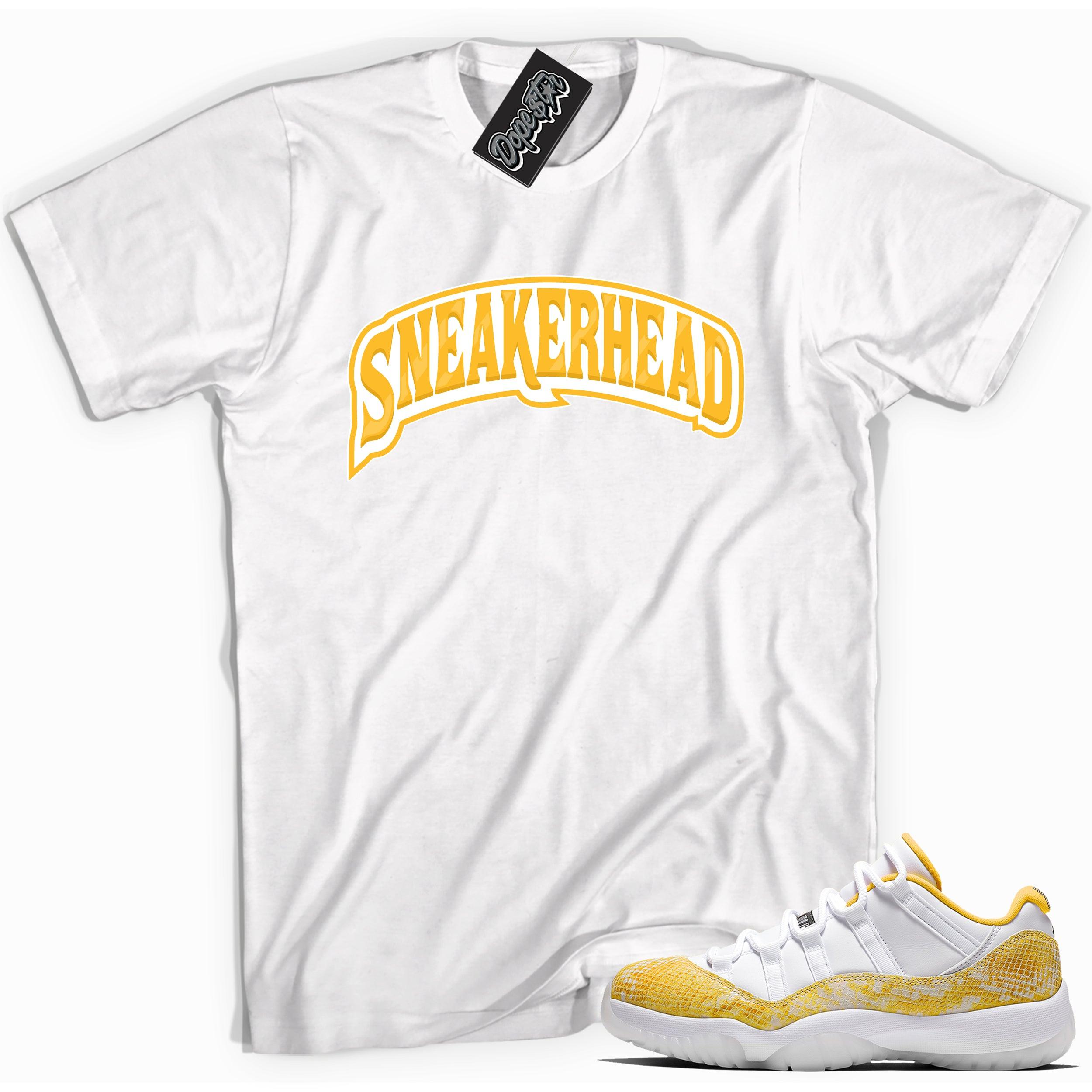 Cool white graphic tee with 'sneaker head' print, that perfectly matches Air Jordan 11 Retro Low Yellow Snakeskin sneakers