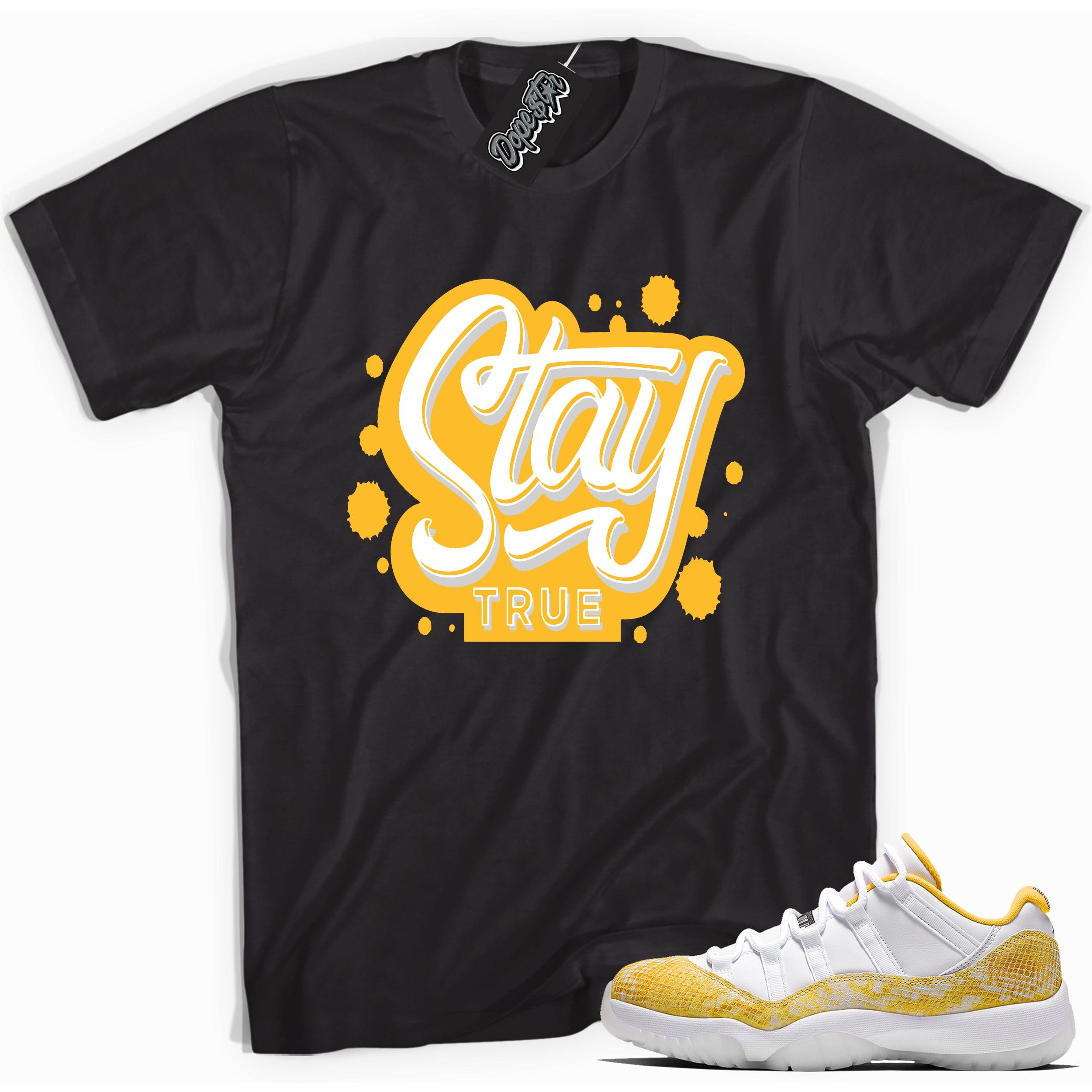 Cool black graphic tee with 'stay true' print, that perfectly matches  Air Jordan 11 Retro Low Yellow Snakeskin sneakers