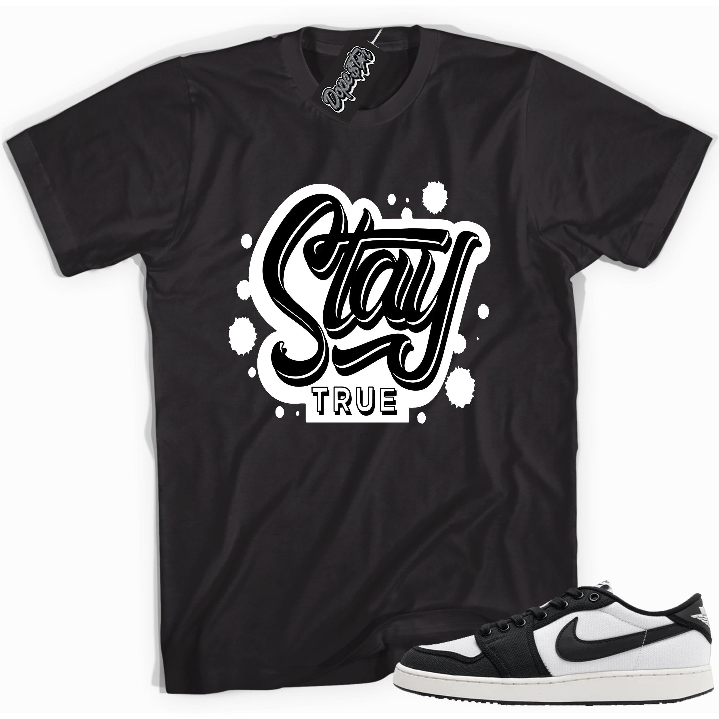 Cool black graphic tee with 'stay true' print, that perfectly matches Air Jordan 1 Retro Ajko Low Black & White sneakers.