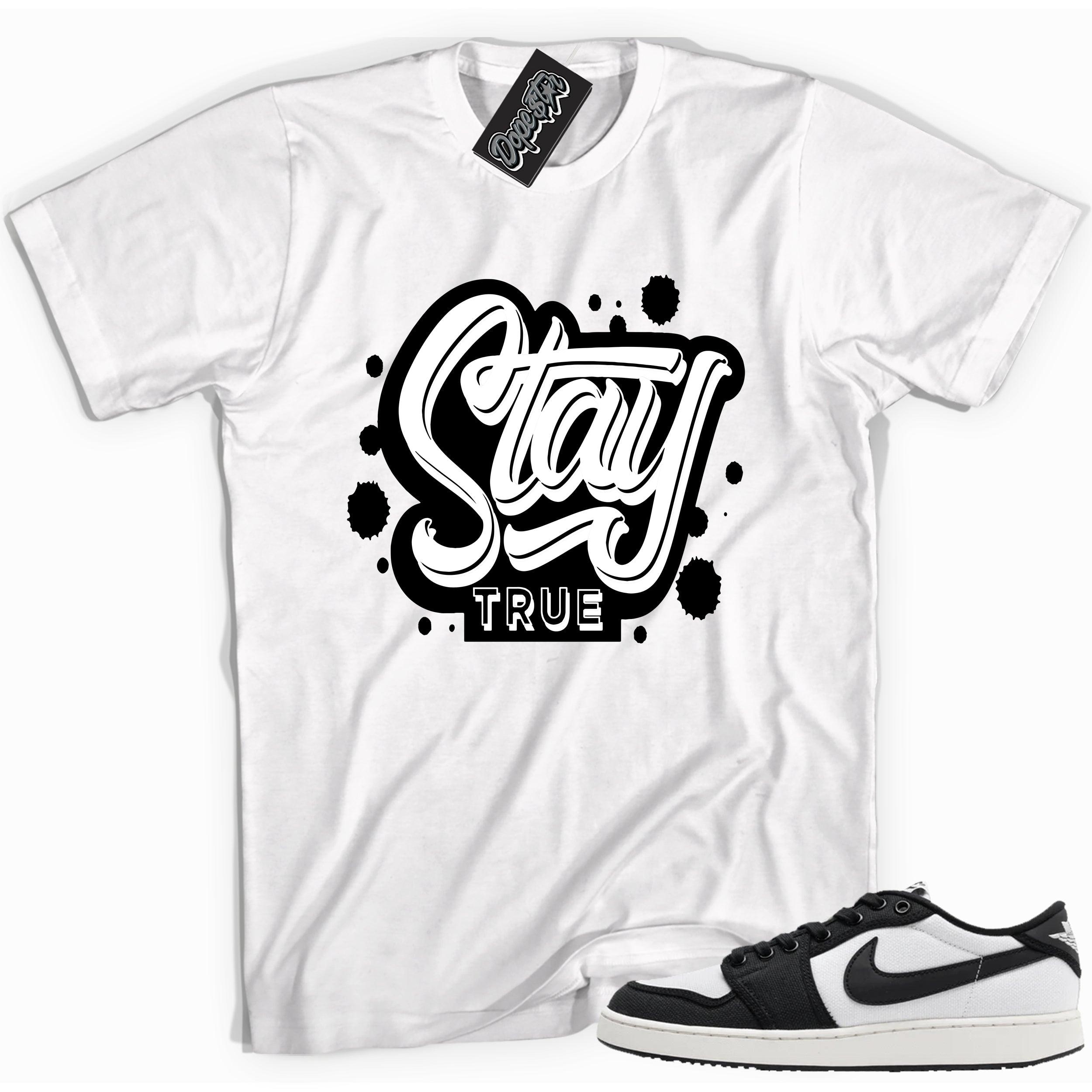 Cool white graphic tee with 'stay true' print, that perfectly matches Air Jordan 1 Retro Ajko Low Black & White sneakers.