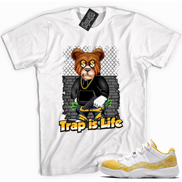 Cool white graphic tee with 'trap is life' print, that perfectly matches Air Jordan 11 Retro Low Yellow Snakeskin sneakers