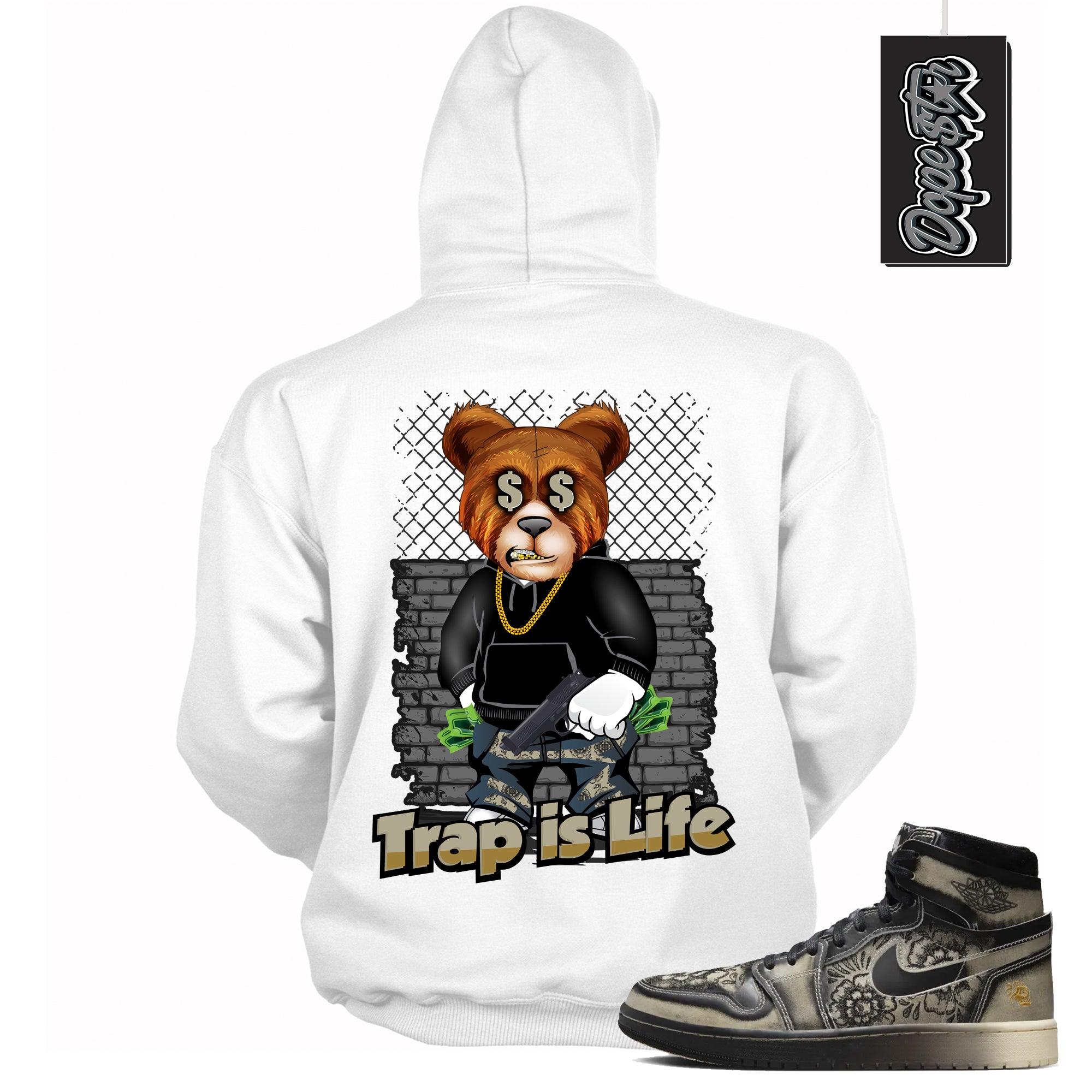 Cool White Graphic Hoodie with “ TRAP IS LIFE “ print, that perfectly matches Air Jordan 1 High Zoom Comfort 2 Dia de Muertos Black and Pale Ivory sneakers