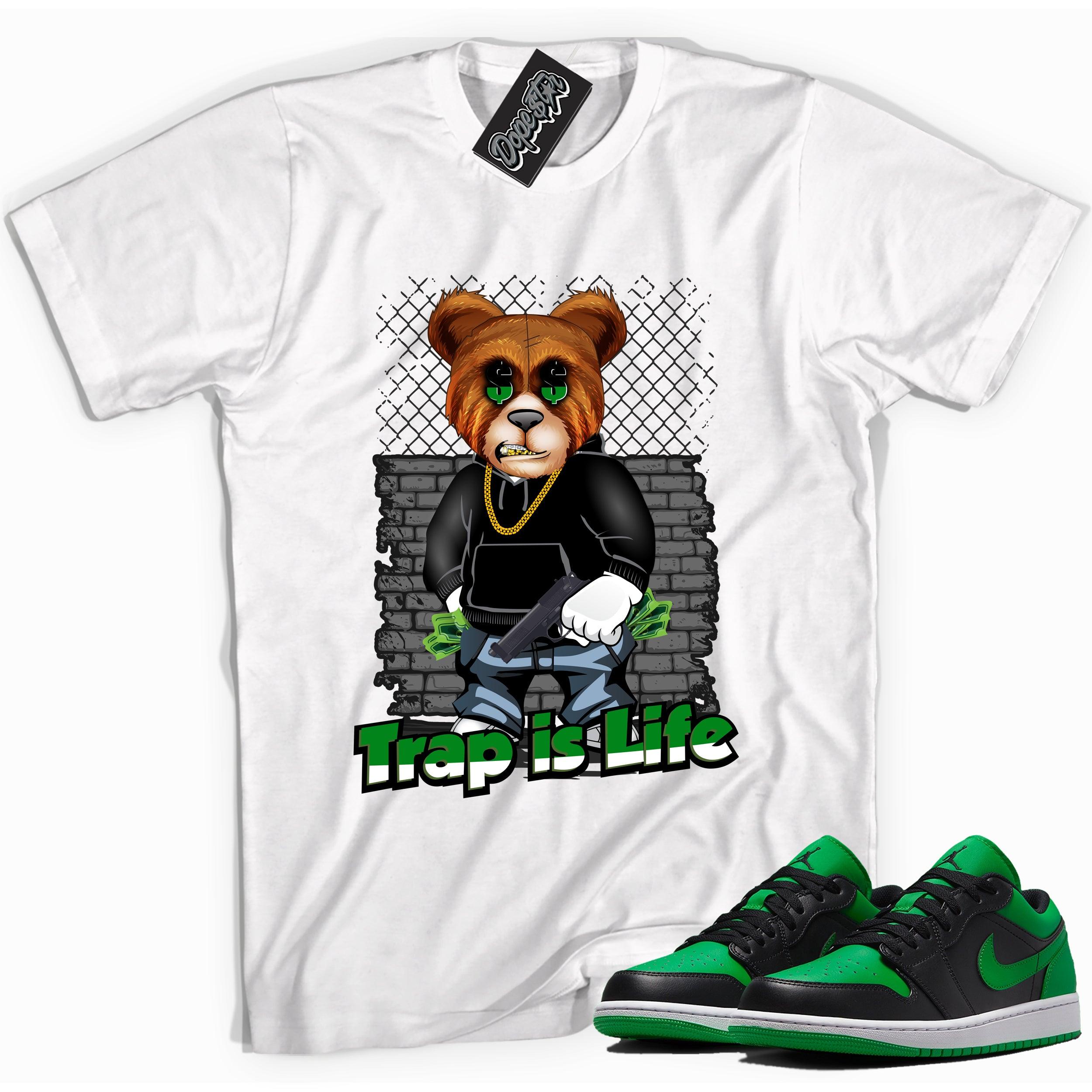 Cool white graphic tee with 'trap is life' print, that perfectly matches Air Jordan 1 Low Lucky Green sneakers