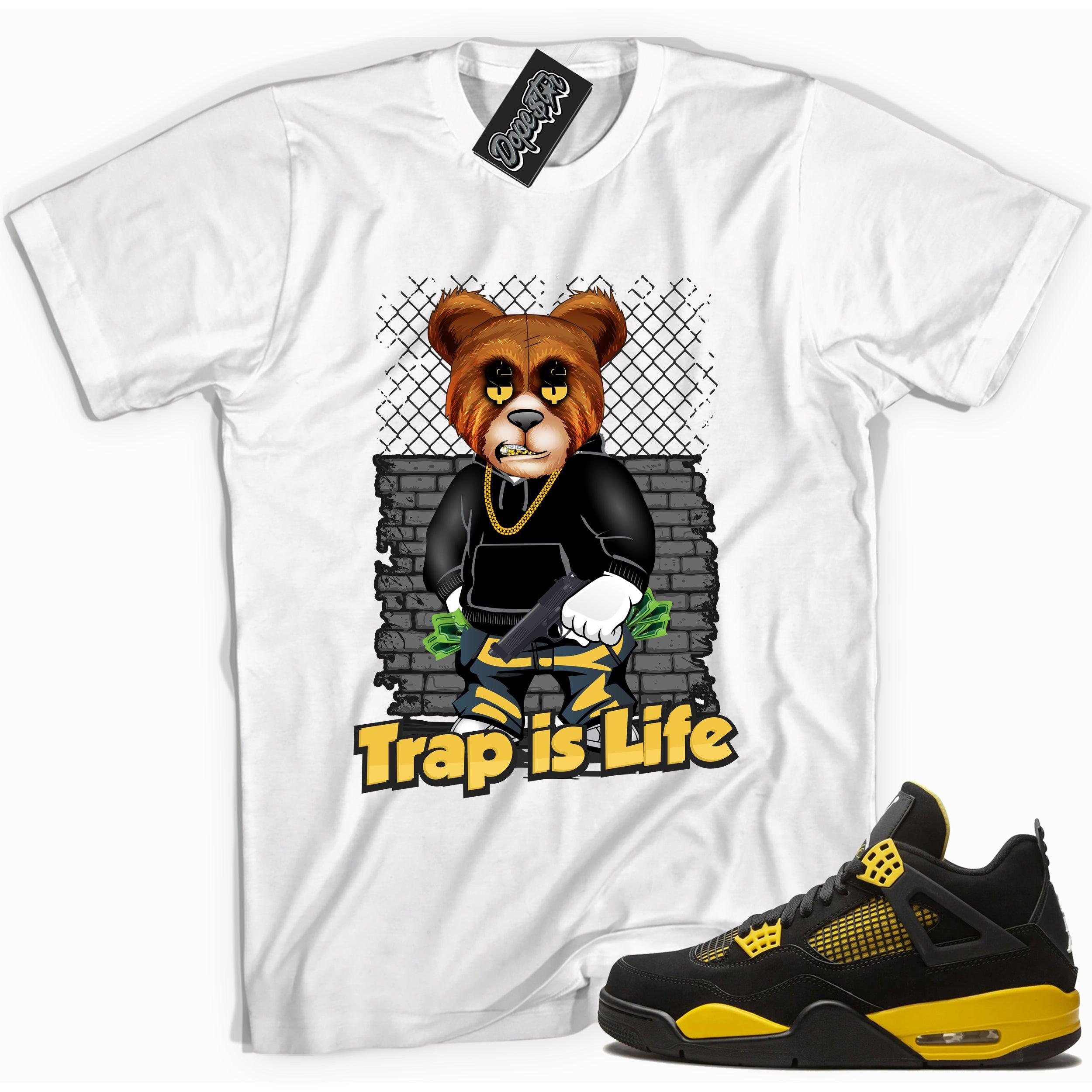 Cool white graphic tee with 'trap is life' print, that perfectly matches Air Jordan 4 Thunder sneakers