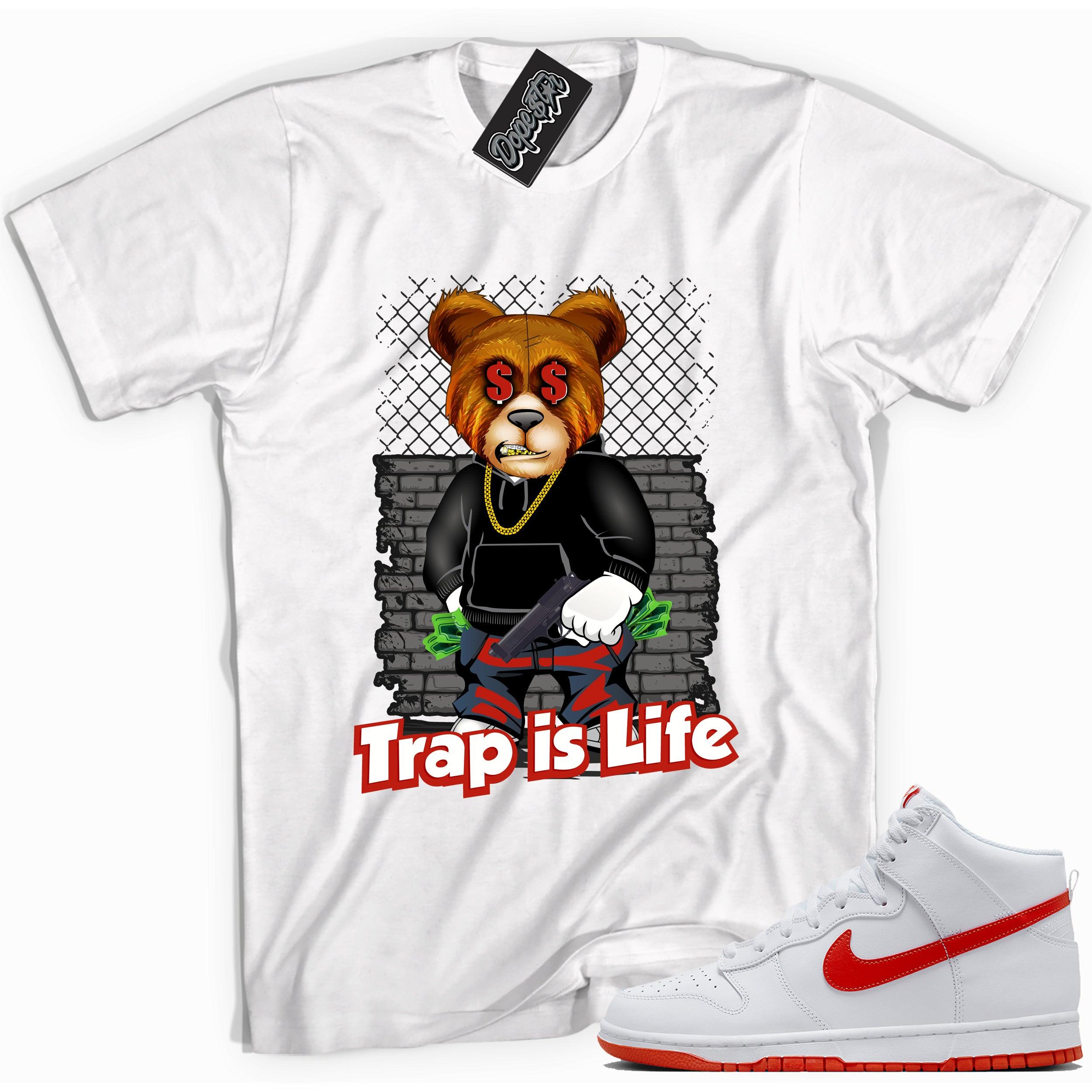 Cool white graphic tee with 'trap is life' print, that perfectly matches Nike Dunk High White Picante Red sneakers.