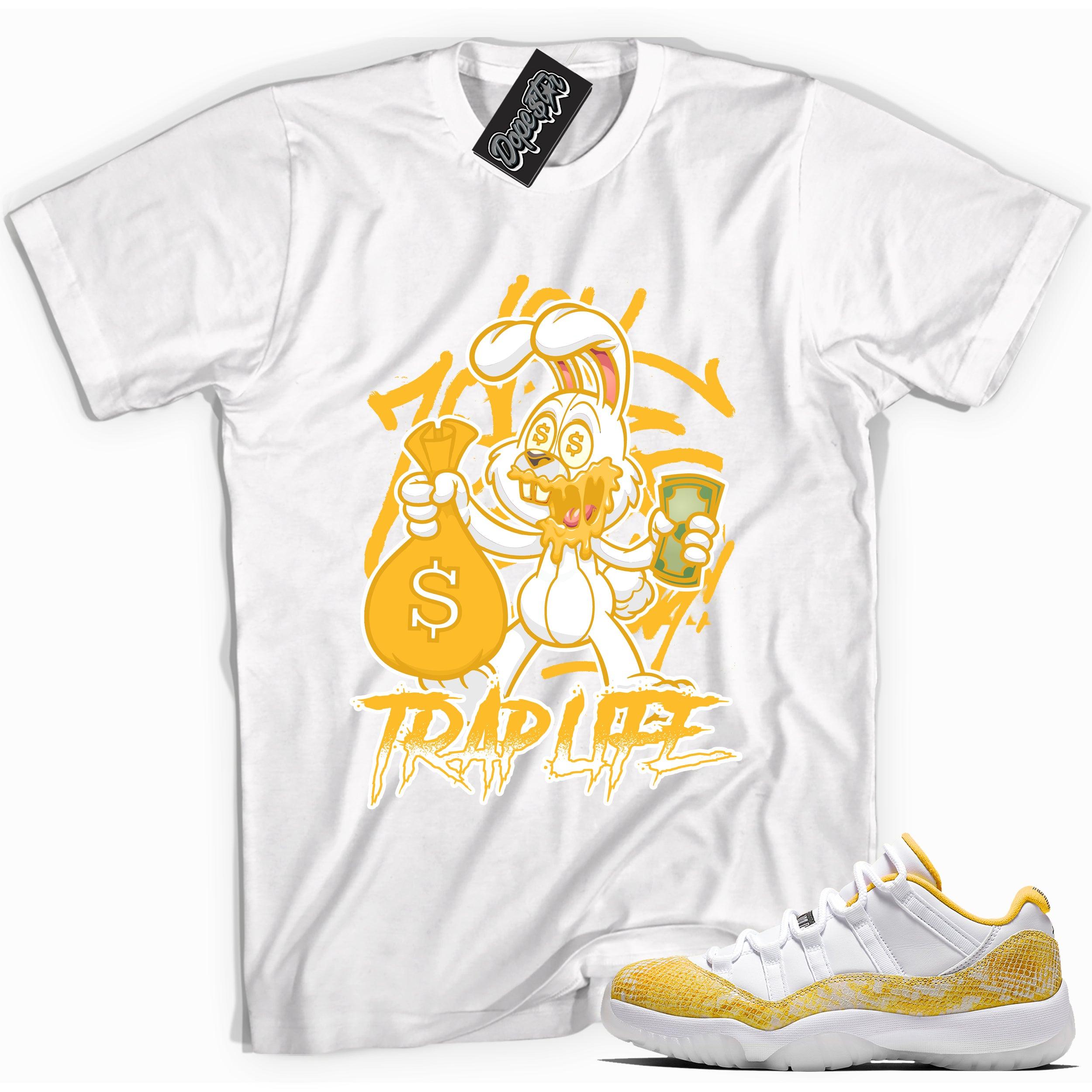 Cool white graphic tee with 'trap life rabbit' print, that perfectly matches Air Jordan 11 Retro Low Yellow Snakeskin sneakers