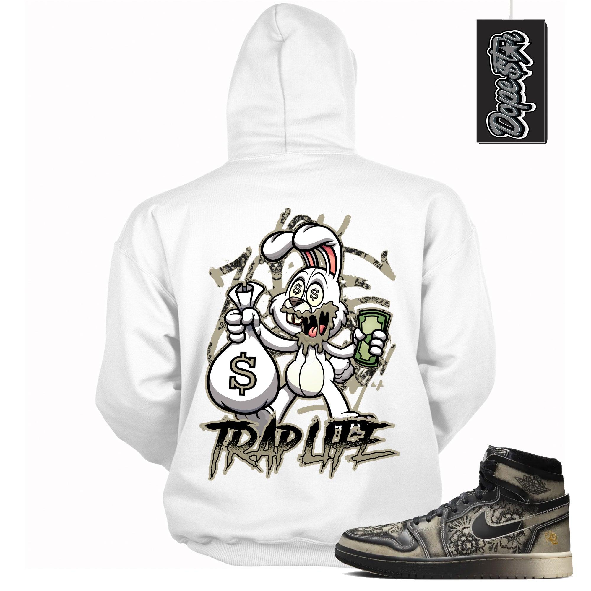 Cool White Graphic Hoodie with “ Trap Rabbit “ print, that perfectly matches Air Jordan 1 High Zoom Comfort 2 Dia de Muertos Black and Pale Ivory sneakers