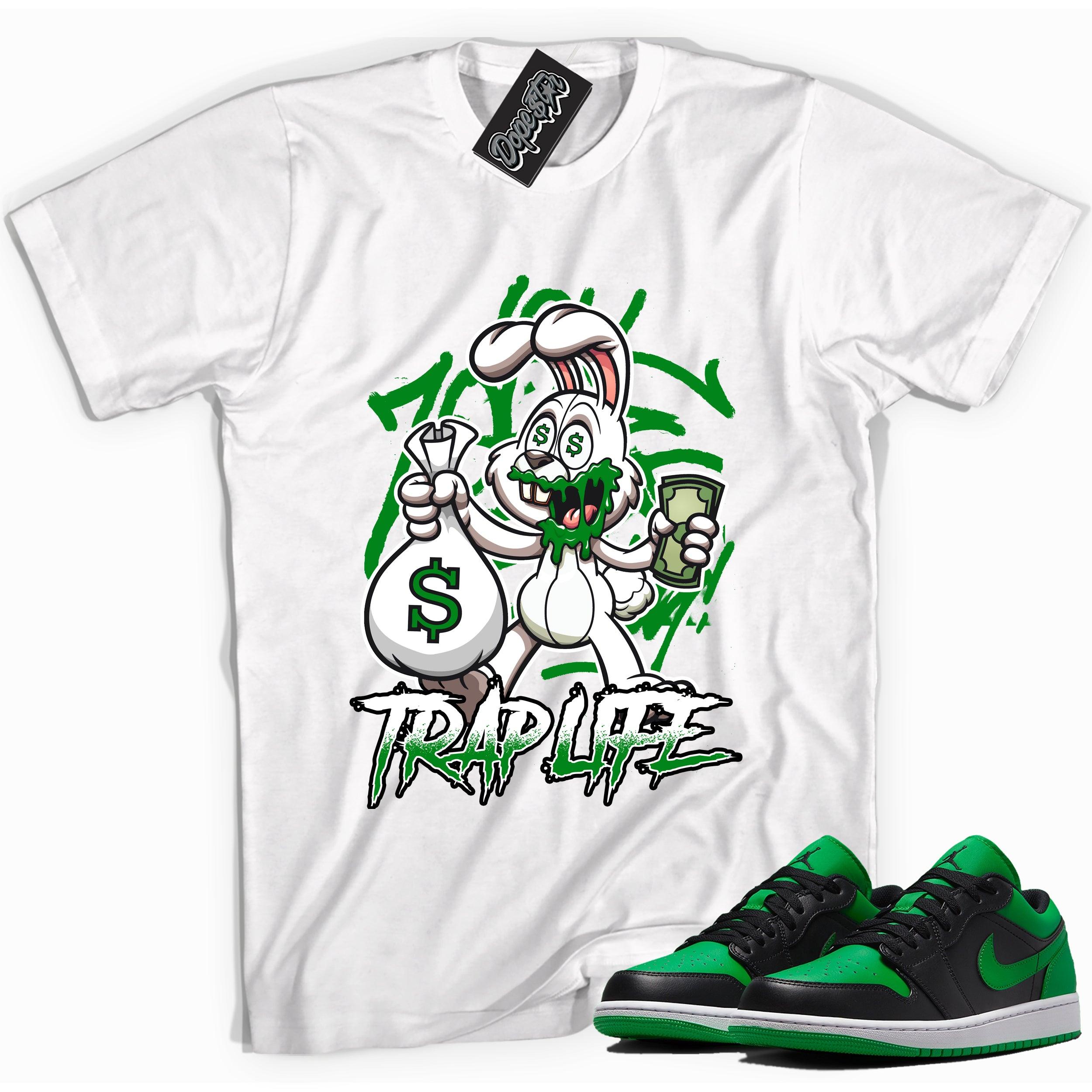 Cool white graphic tee with 'trap life rabbit' print, that perfectly matches Air Jordan 1 Low Lucky Green sneakers