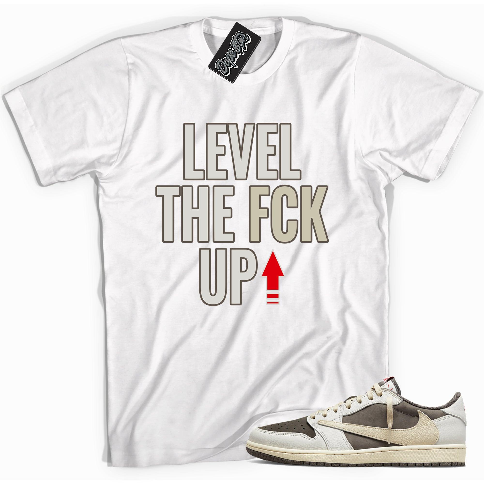 Cool white graphic tee with 'Level Up' print, that perfectly matches Travis Scott's Air Jordan 1 Low 'Reverse Mocha sneakers.