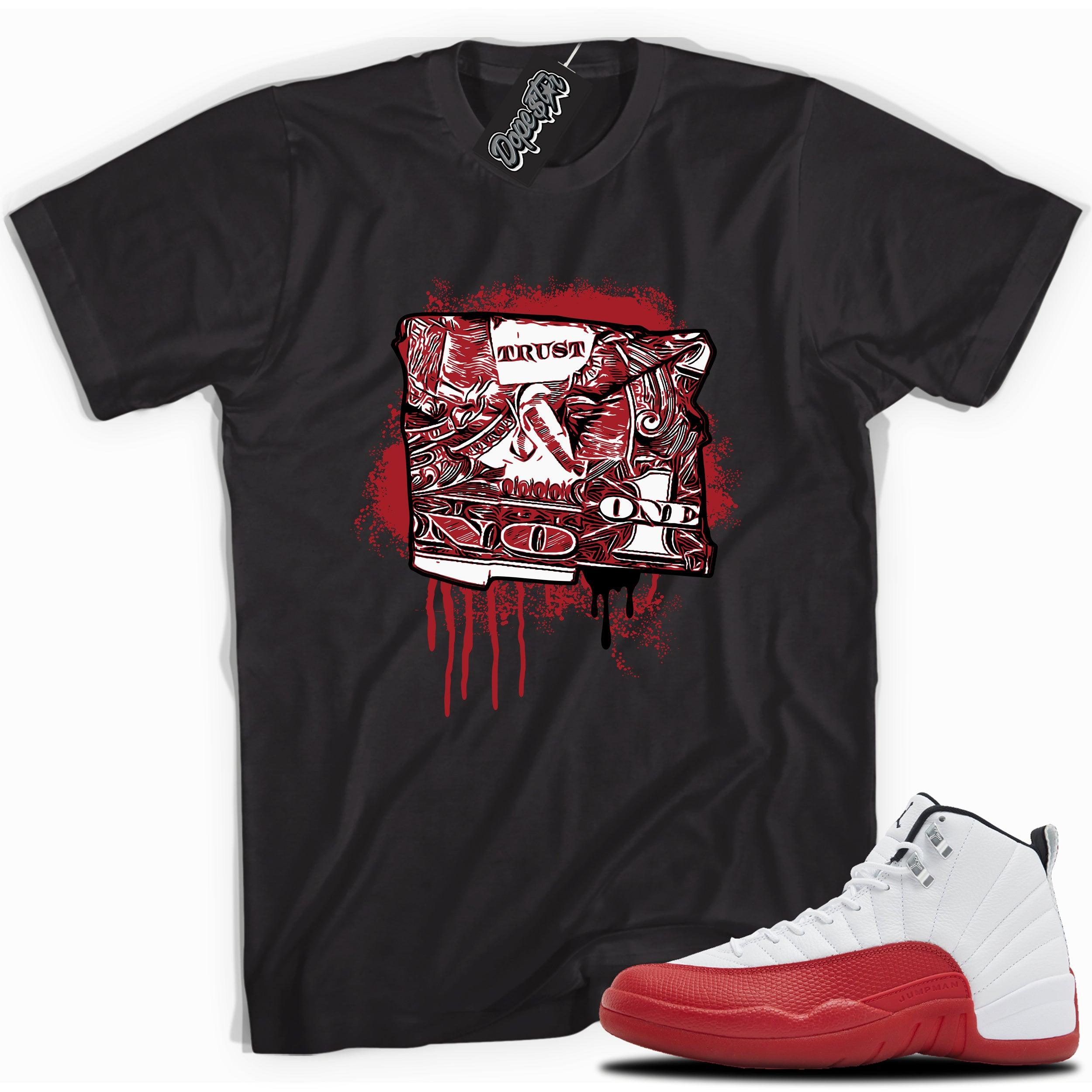 Cool black graphic tee with “Trust No One” print, that perfectly matches Air Jordan 12 Retro Cherry Red 2023 red and white sneakers 