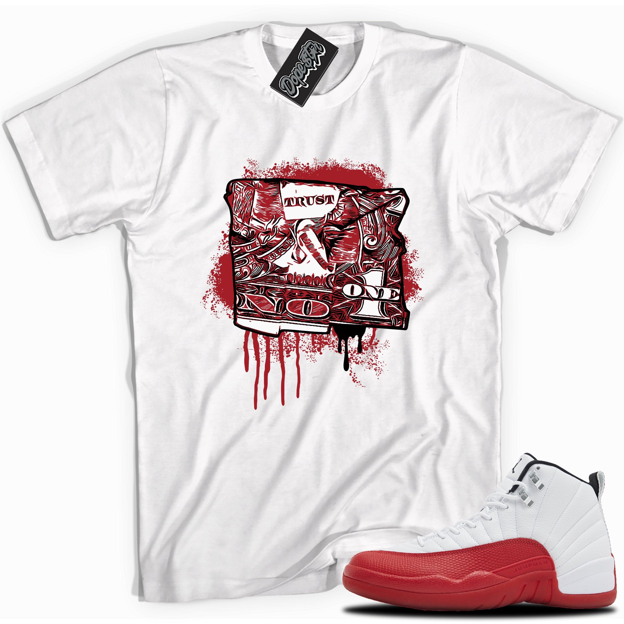 Cool white graphic tee with “Trust No One” print, that perfectly matches Air Jordan 12 Retro Cherry Red 2023 red and white sneakers 