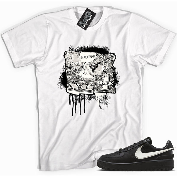 Cool white graphic tee with 'trust no one dollar bill' print, that perfectly matches Nike Air Force 1 Low SP Ambush Phantom sneakers.