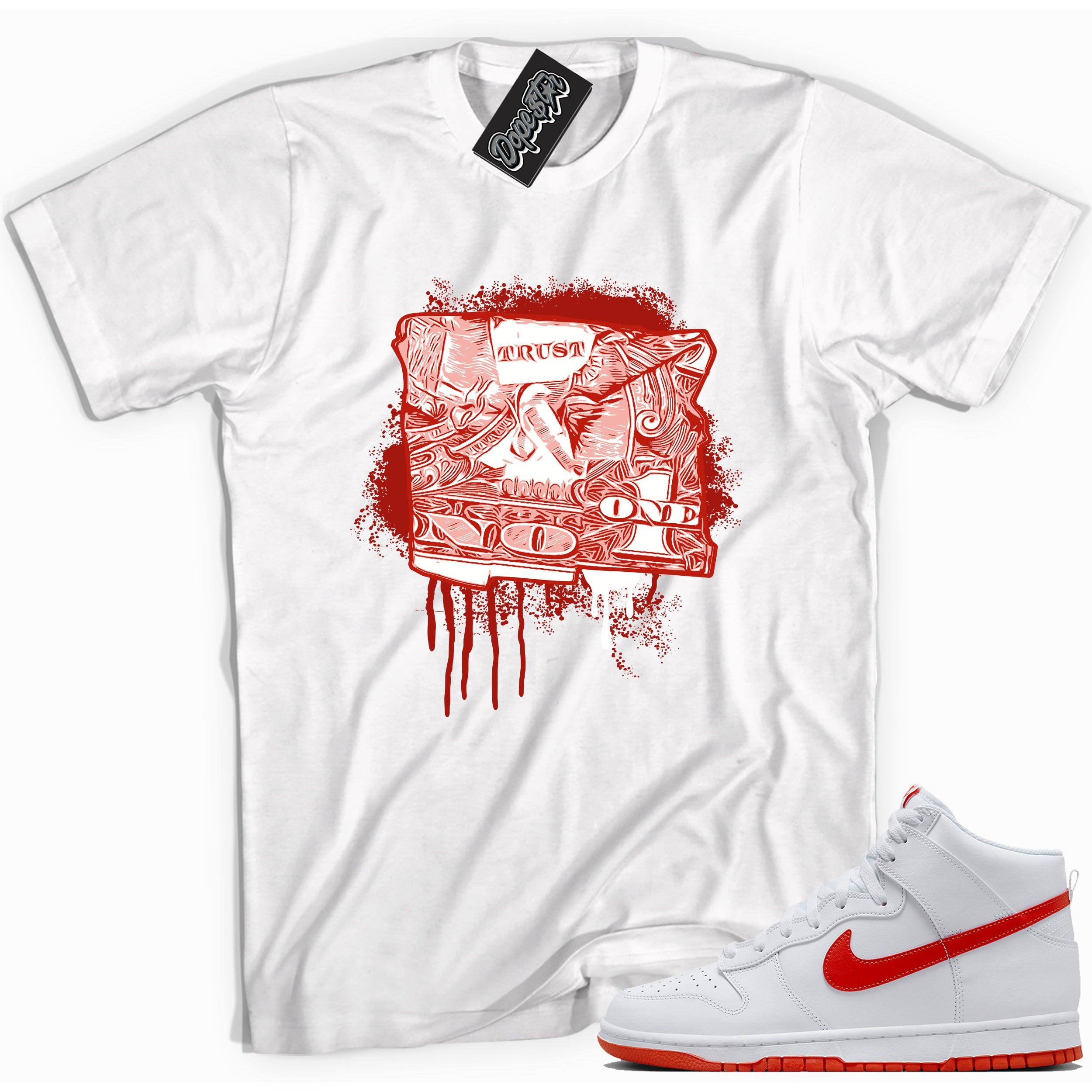 Cool white graphic tee with 'trust no one dollar bill' print, that perfectly matches Nike Dunk High White Picante Red sneakers.