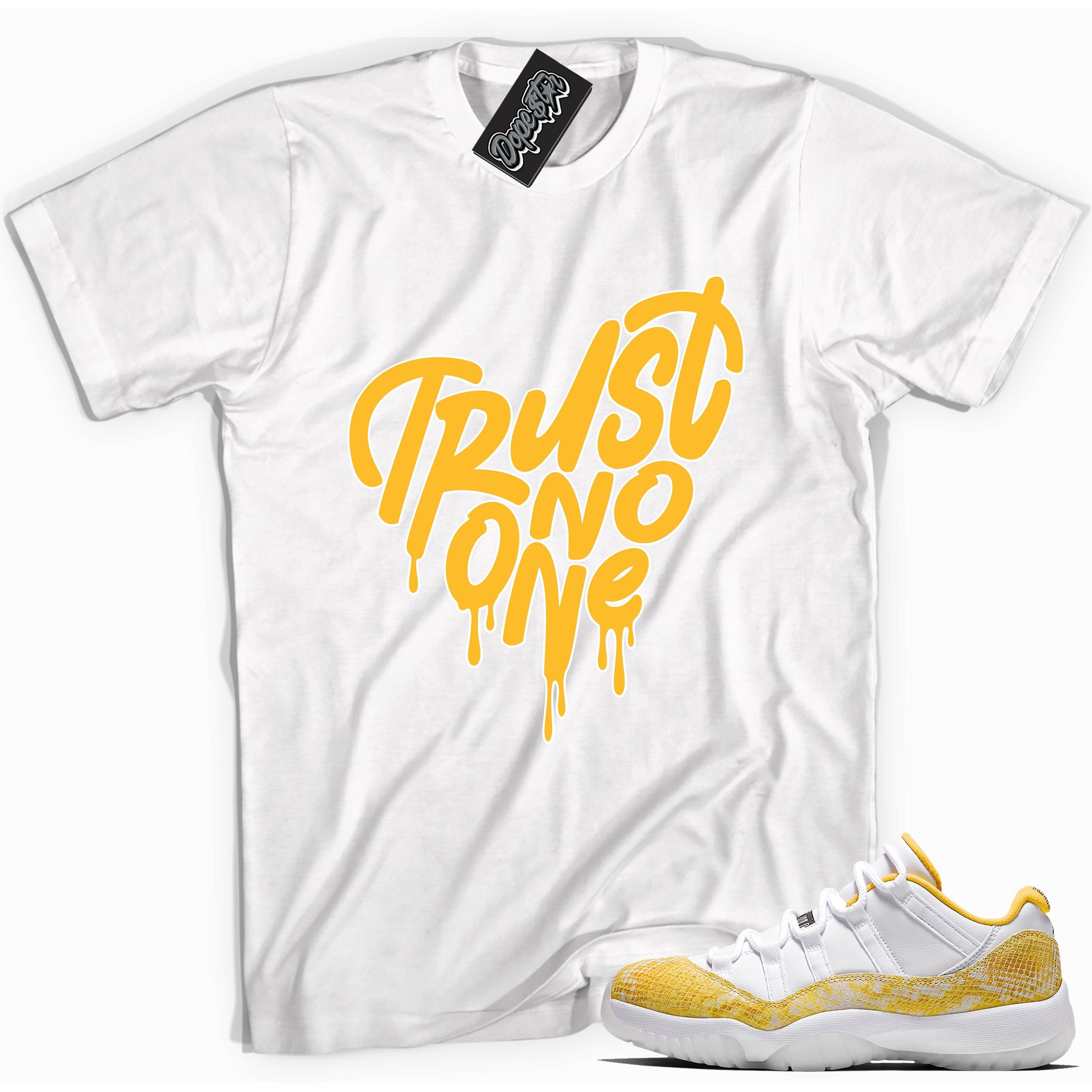 Cool white graphic tee with 'trust no one' print, that perfectly matches Air Jordan 11 Retro Low Yellow Snakeskin sneakers