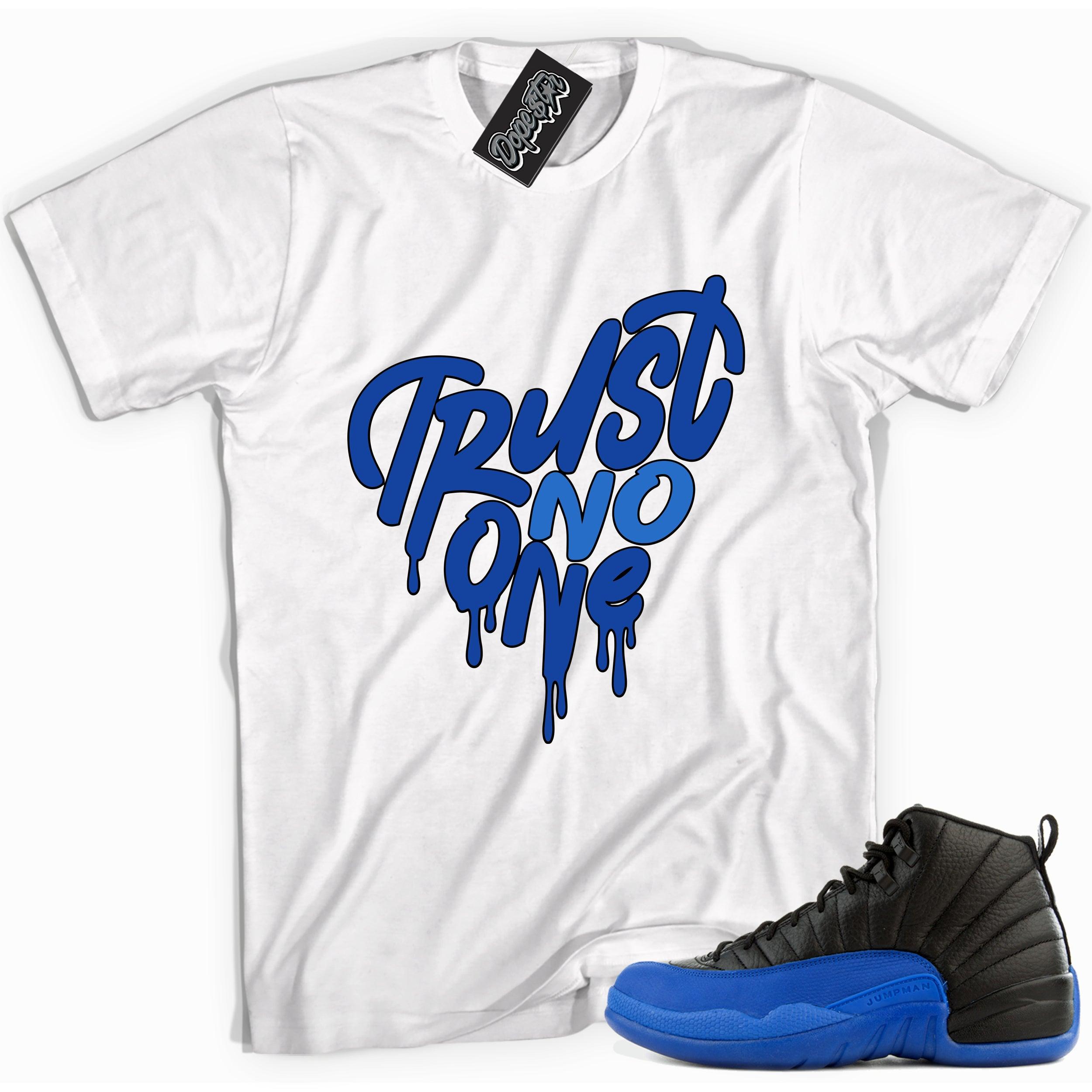 Cool white graphic tee with 'trust no one' print, that perfectly matches Air Jordan 12 Retro Black Game Royal sneakers.