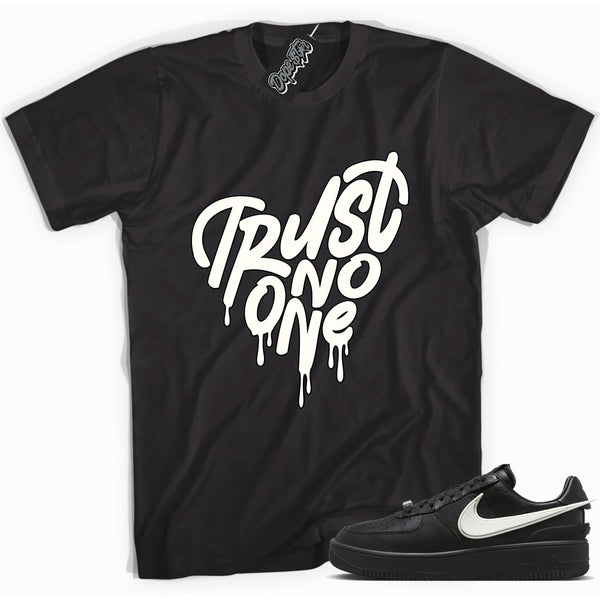 Cool black graphic tee with 'trust no one heart' print, that perfectly matches Nike Air Force 1 Low SP Ambush Phantom sneakers.