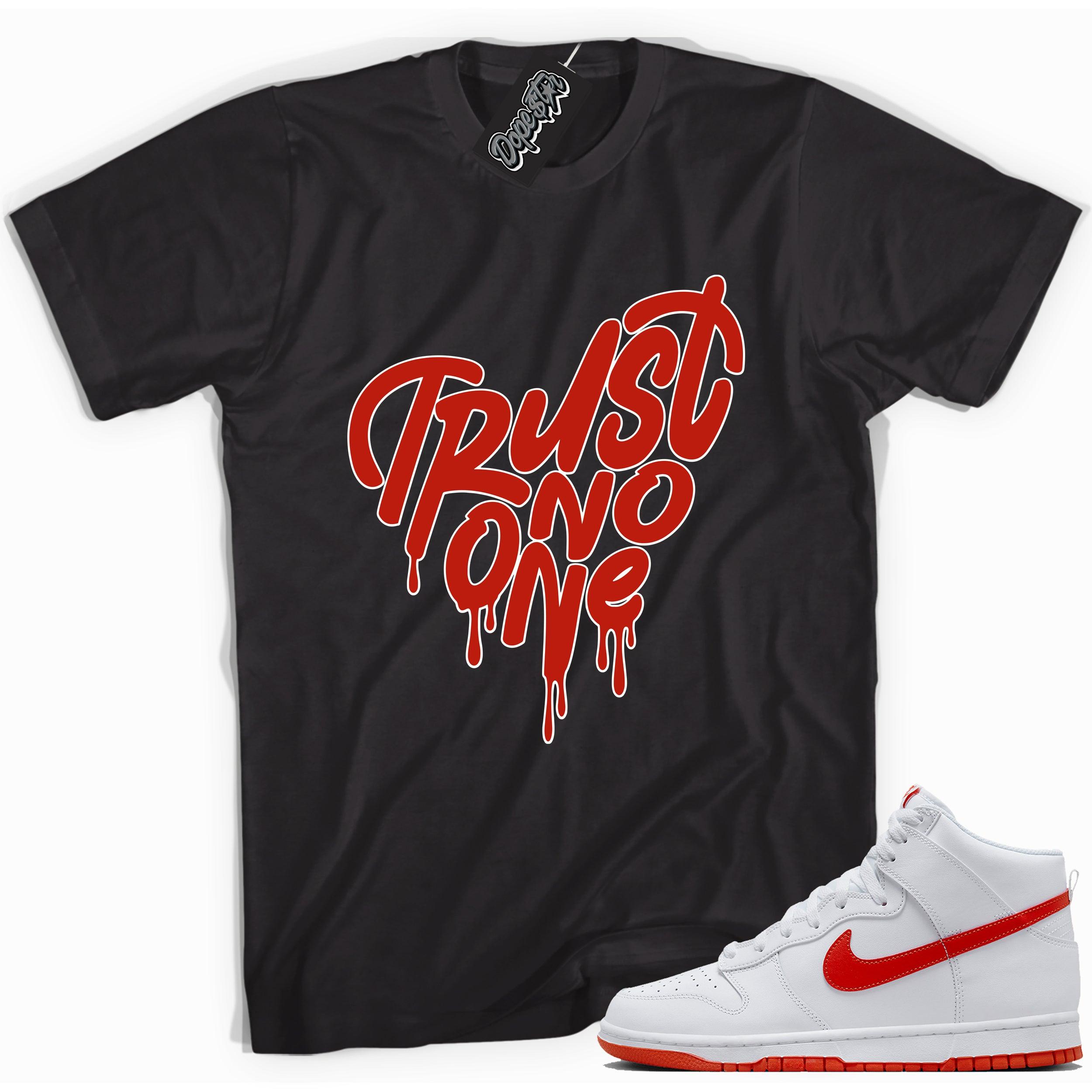 Cool black graphic tee with 'trust no one heart' print, that perfectly matches Nike Dunk High White Picante Red sneakers.