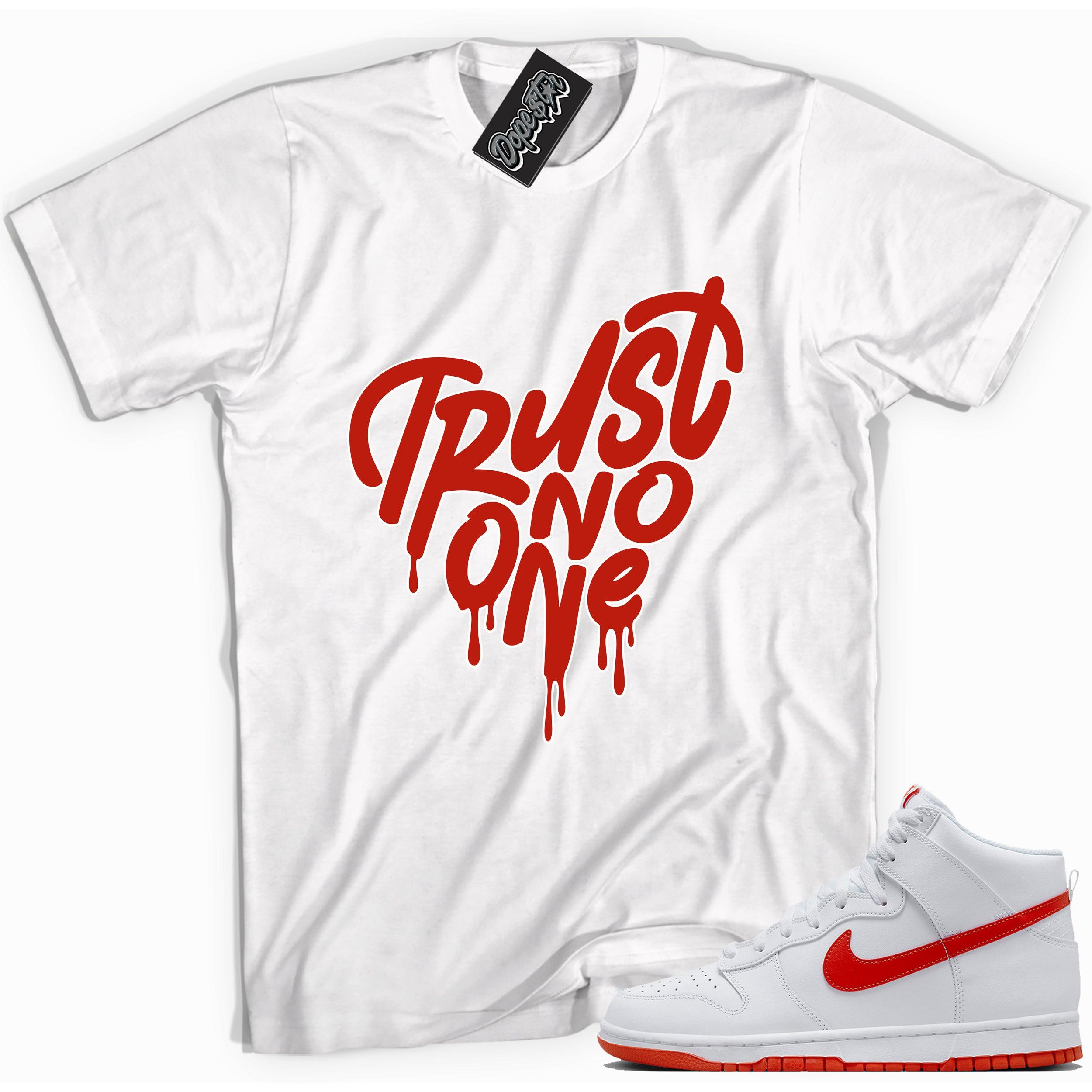 Cool white graphic tee with 'trust no one heart' print, that perfectly matches Nike Dunk High White Picante Red sneakers.