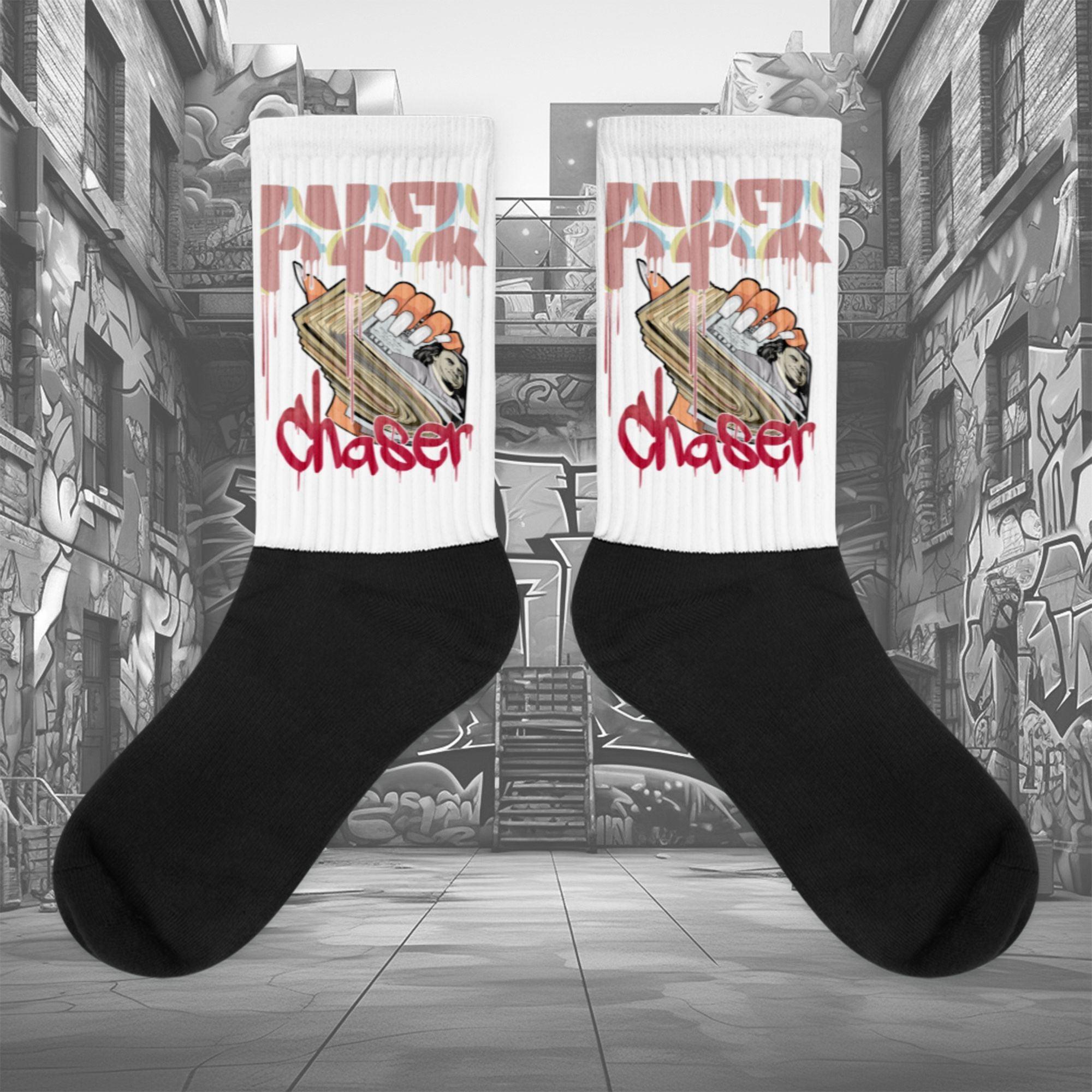  Showcases the view of the socks, highlighting the vibrant ‘Paper Chaser’ design, which perfectly complements the Air Jordan 1 Retro High OG Next Chapter Spider-Verse sneakers. The intricate pattern and color scheme inspired by the Spider-Verse theme are prominently displayed.  Focusing on the ribbed leg , cusioned bottoms and the snug fit of the socks. This angle provides a clear view of the texture and quality of the material blend.