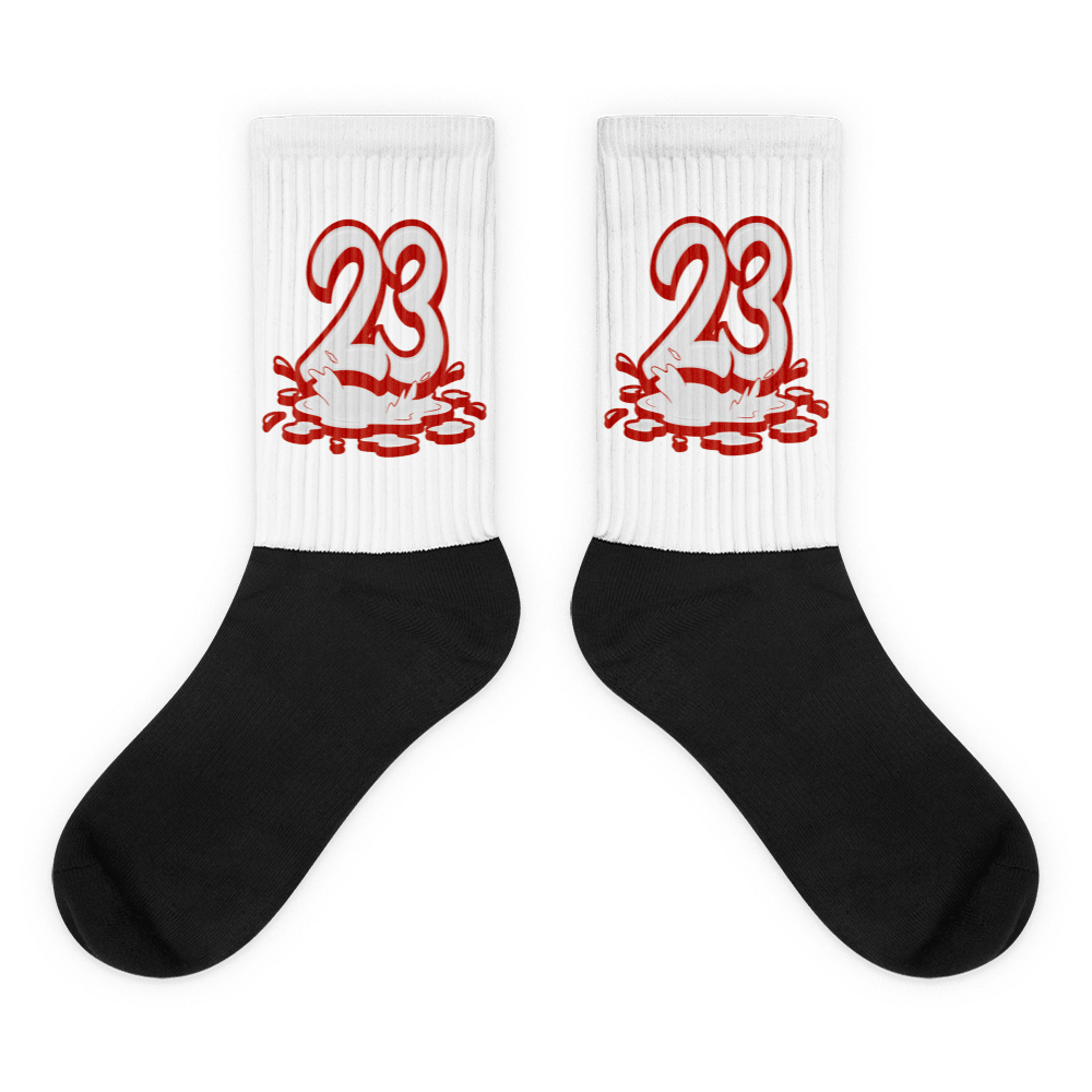  Showcases the view of the socks, highlighting the vibrant ' 23 Melting ' design, which perfectly complements the Air Jordan 11 Cherry sneakers. The intricate pattern and color scheme inspired by the  theme are prominently displayed.  Focusing on the ribbed leg , cusioned bottoms and the snug fit of the socks. This angle provides a clear view of the texture and quality of the material blend.