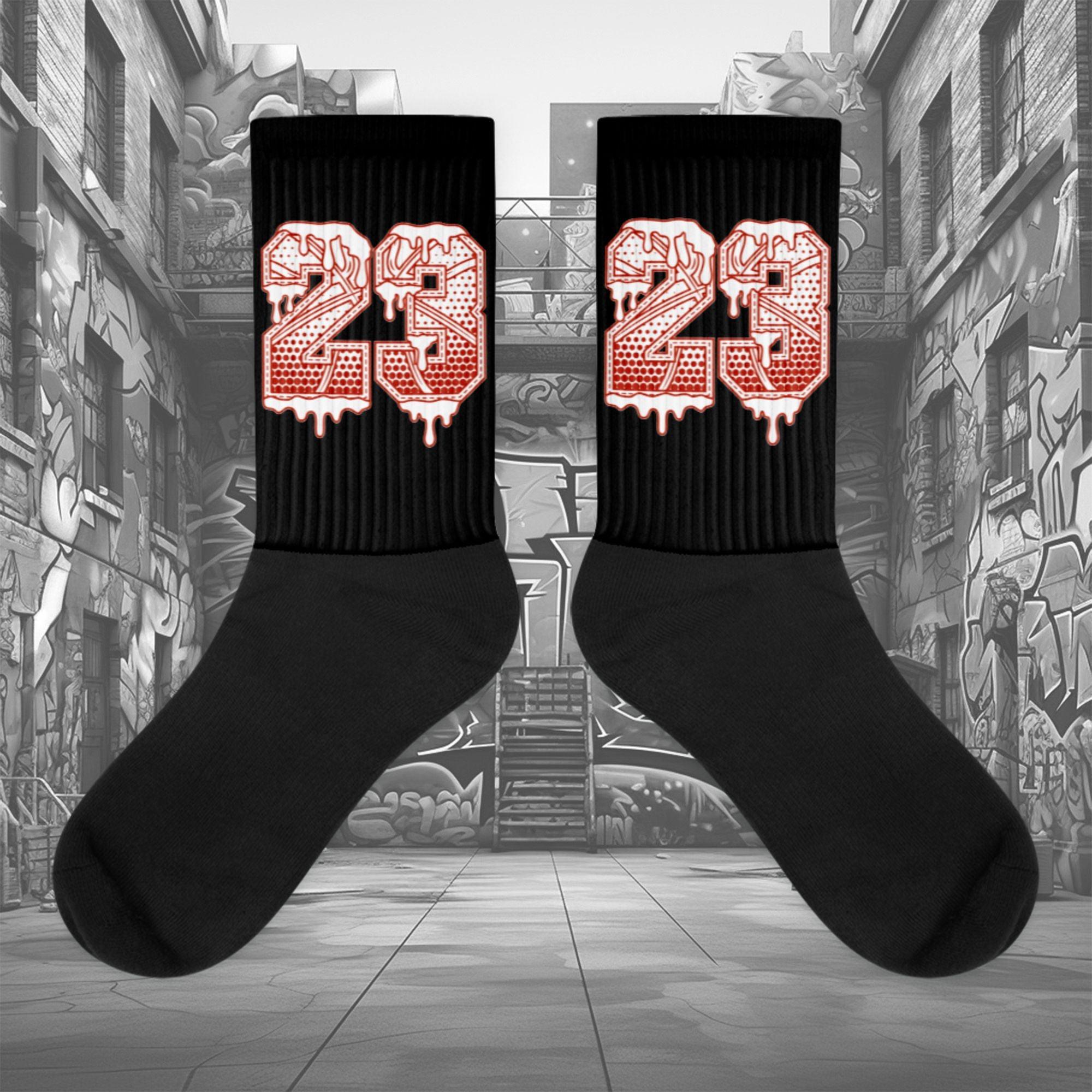  Showcases the view of the socks, highlighting the vibrant ' 23 Ball ' design, which perfectly complements the Air Jordan 11 Cherry sneakers. The intricate pattern and color scheme inspired by the  theme are prominently displayed.  Focusing on the ribbed leg , cusioned bottoms and the snug fit of the socks. This angle provides a clear view of the texture and quality of the material blend